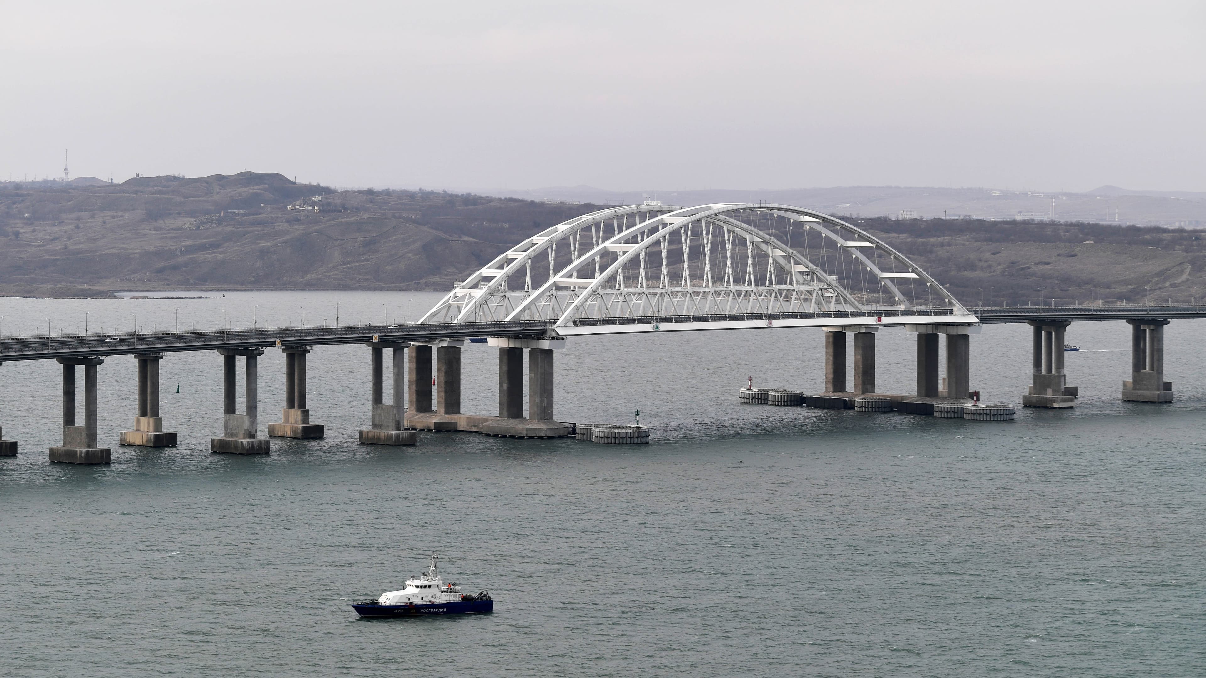 An aerial view shows a road-and-rail bridge