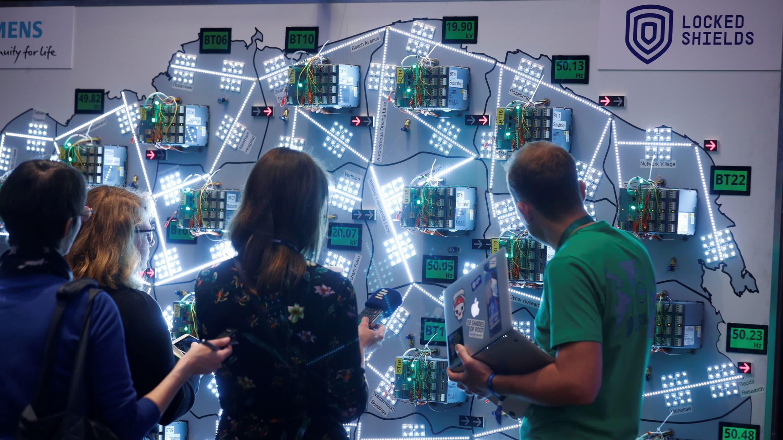 People look at a visualization on a wall