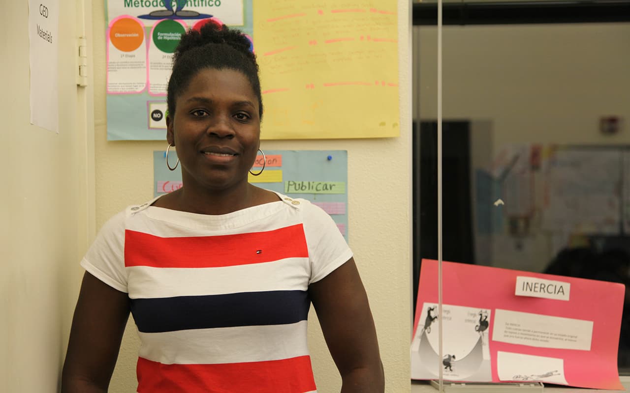 A woman stands in a classroom