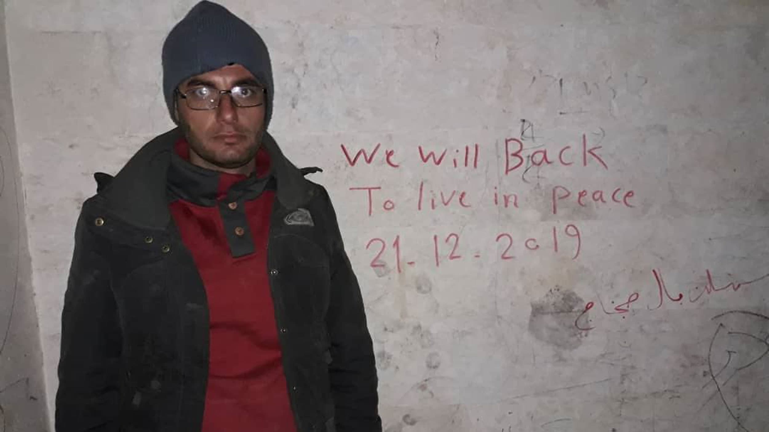 A portrait of Muhmmad Alkassom taken in front of his house.