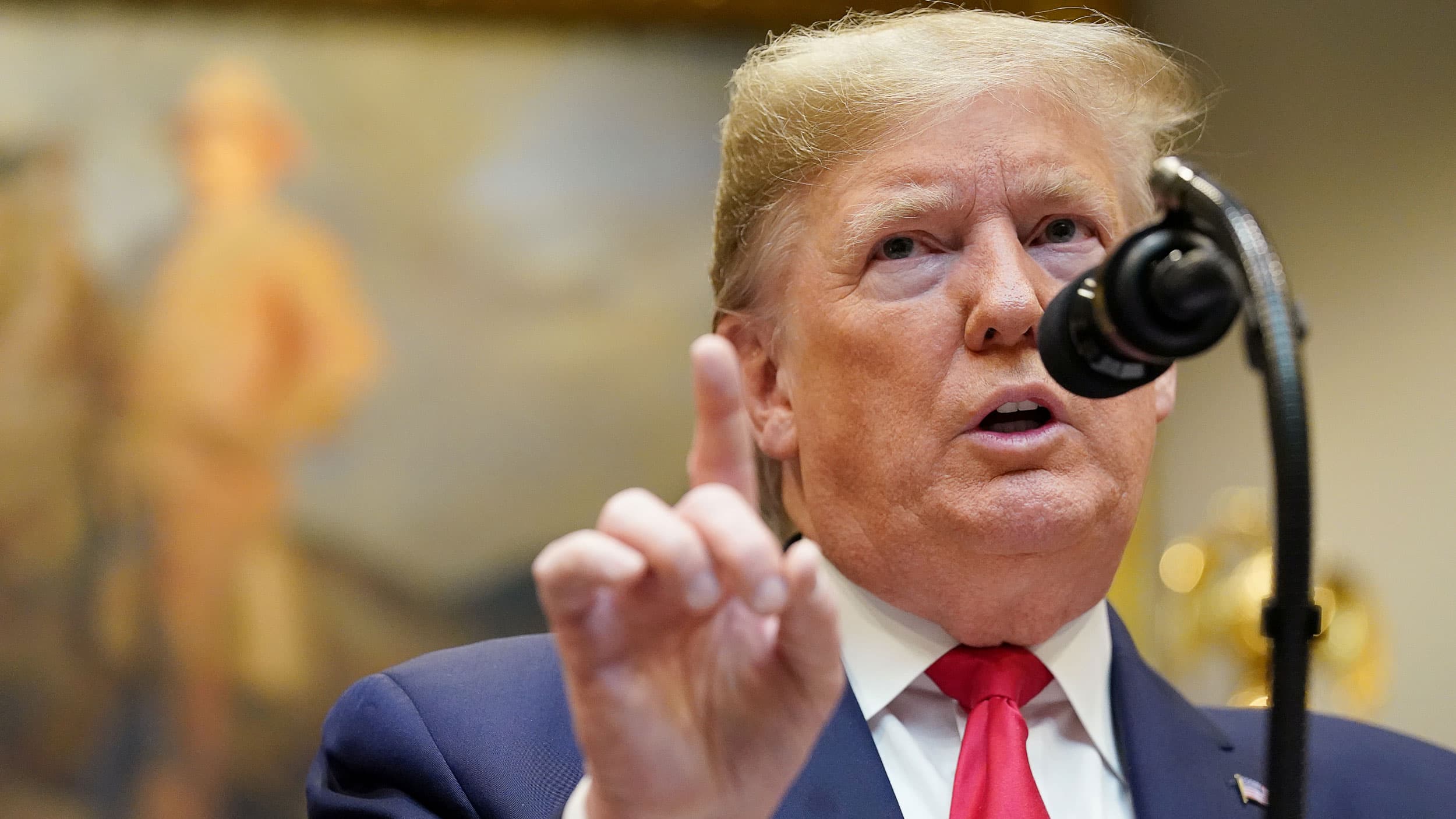 A close-up of President Donald Trump raising his index finger.