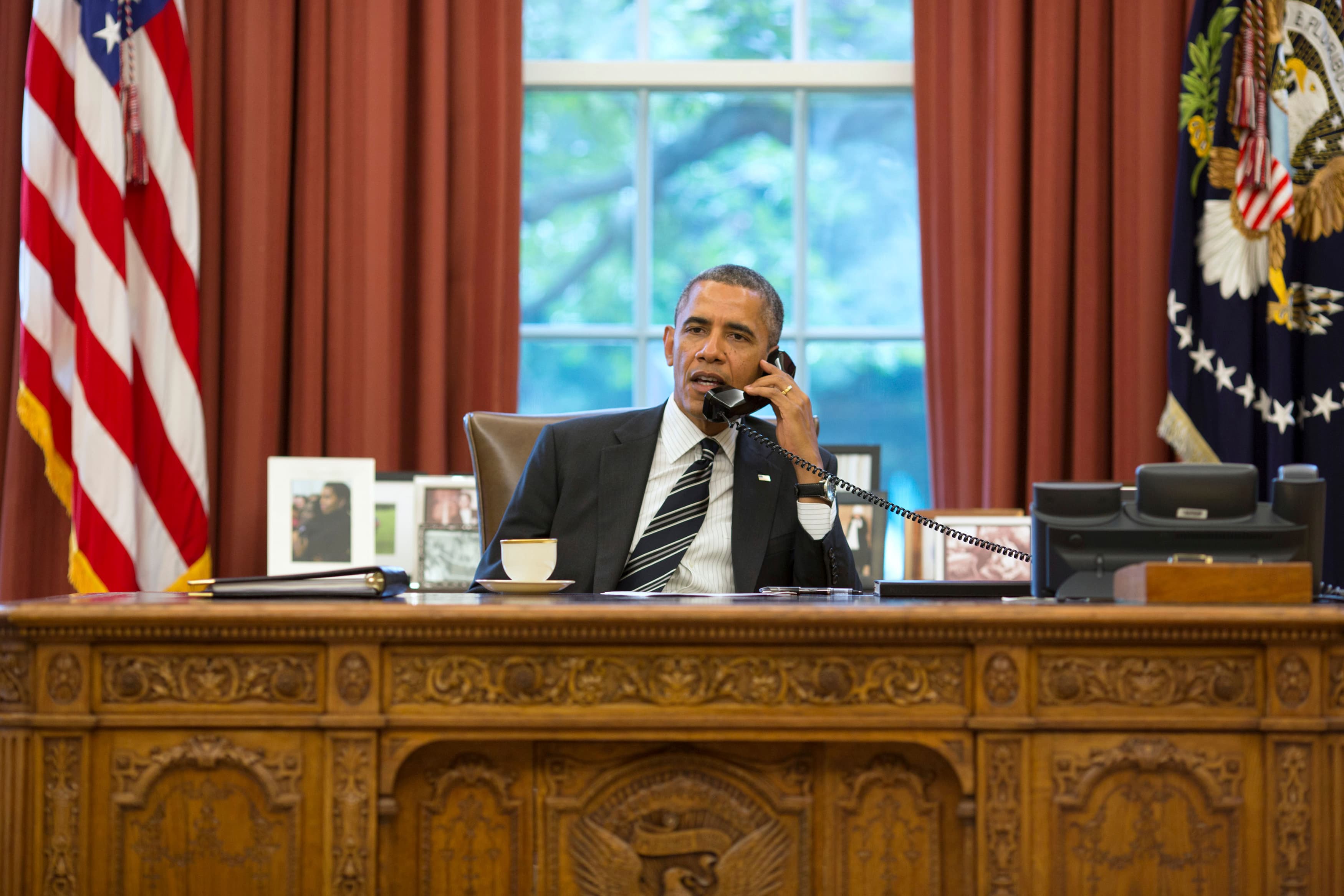 US President Barack Obama talks with Iranian President Hasan Rouhani during a phone call in the Oval Office September 27, 2013. REUTERS/Pete Souza/The White House