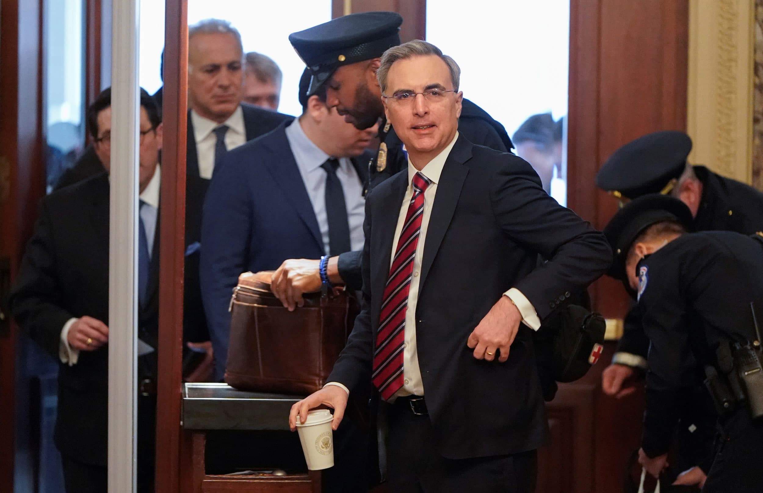 A man in a suit passes through screening