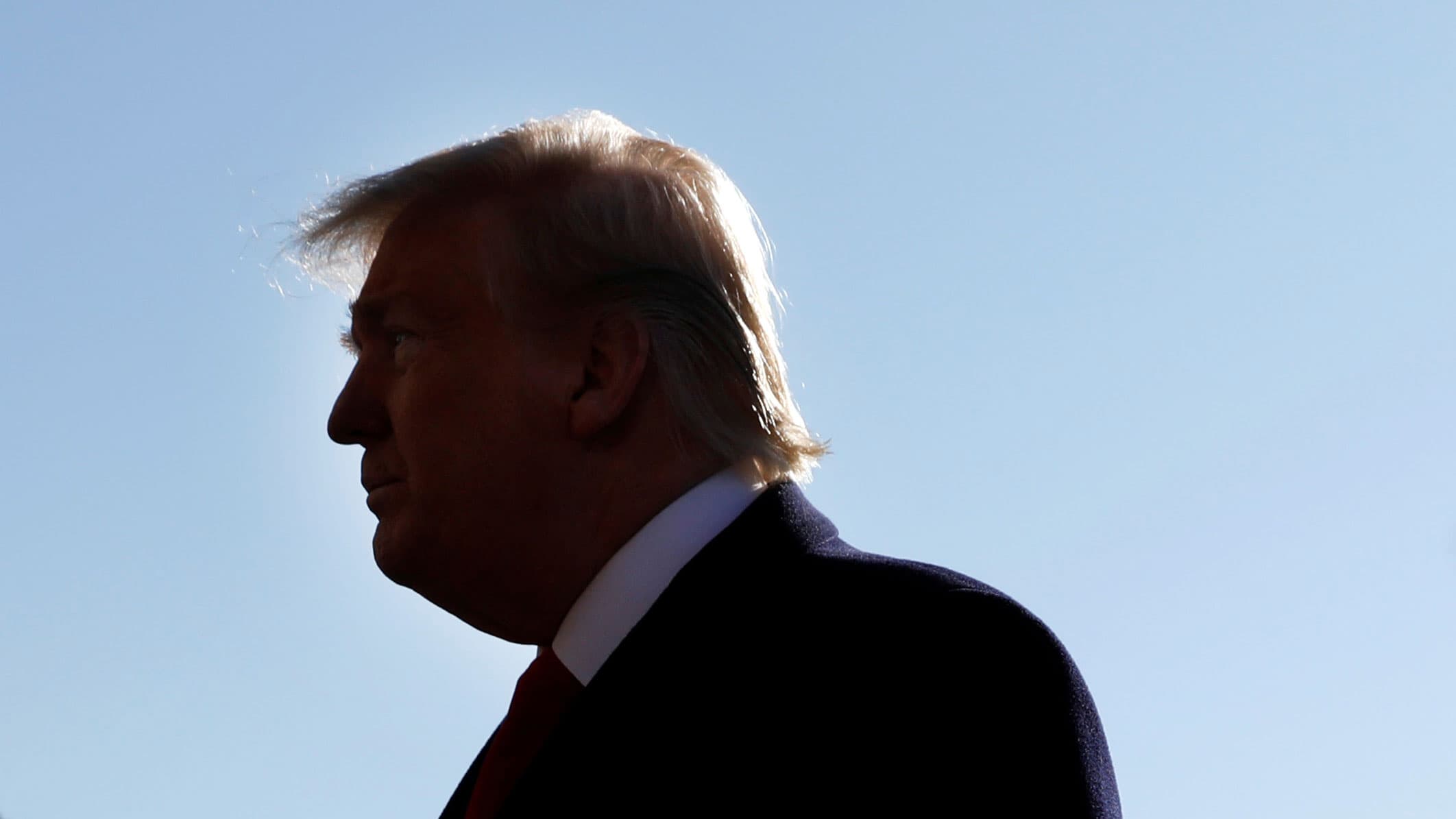 A headshot of Trump in shadow