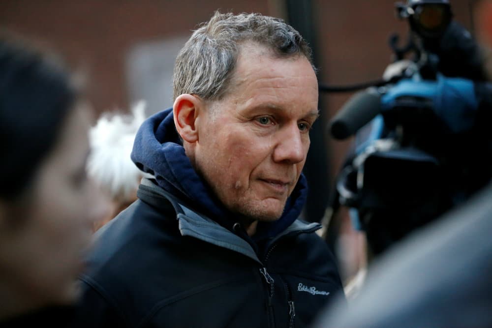 Man walks as cameras follow him.