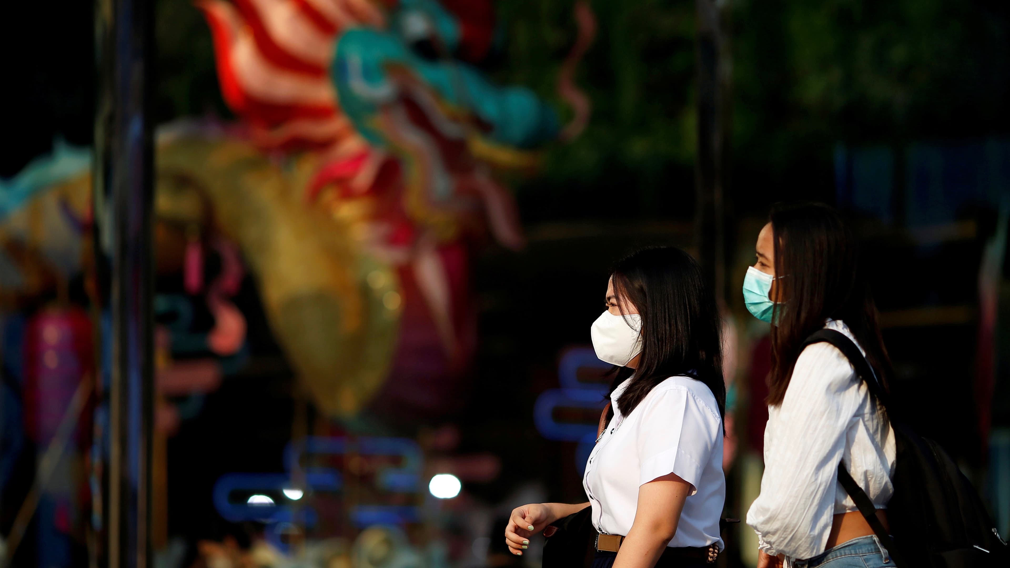 Women wear masks as a preventive measure against the coronavirus outbreak, in Bangkok, Feb. 7, 2020.