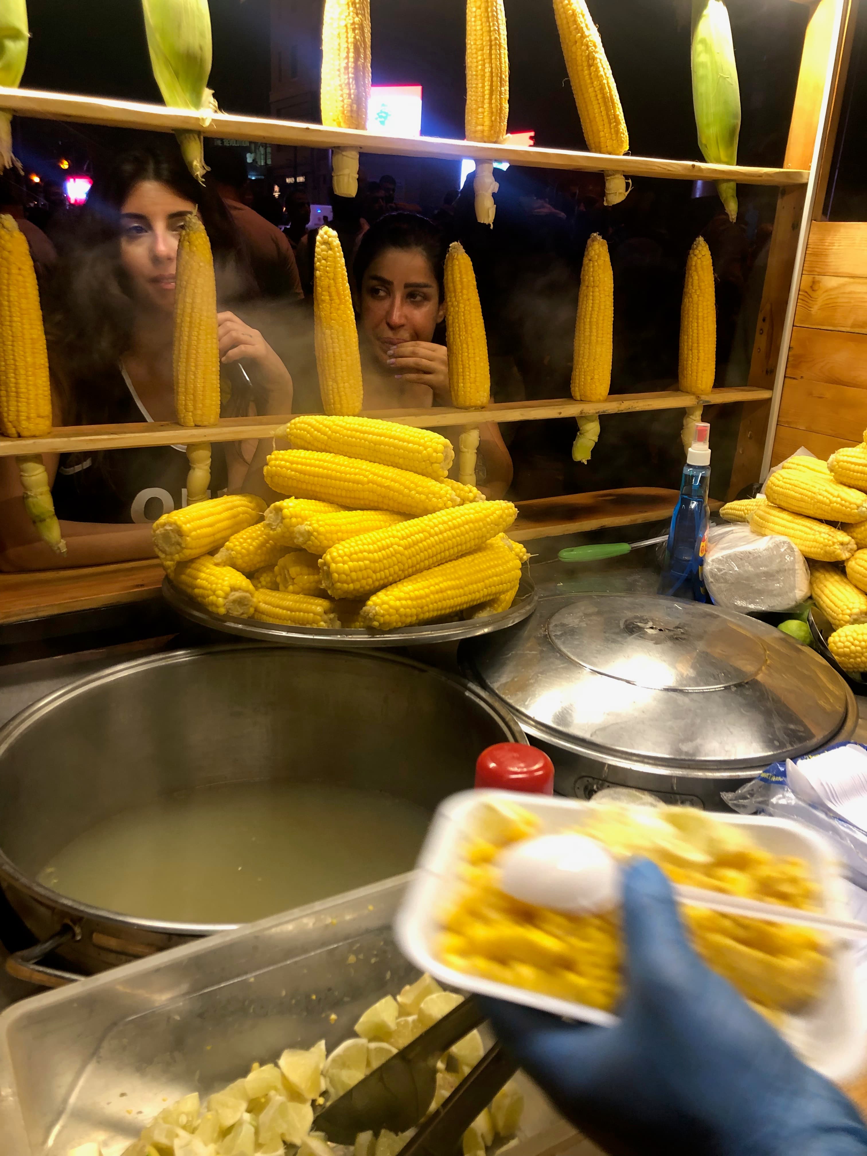 Protesters buy corn from a vendor on Beirut's Ring bridge during a road closure.
