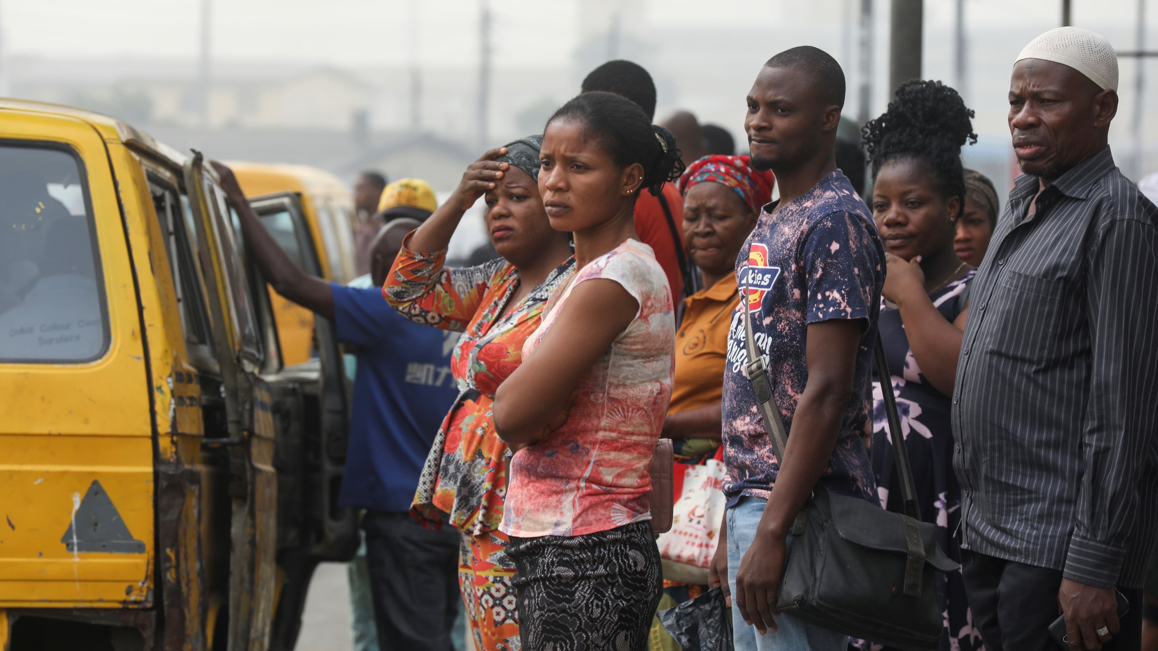 People are seen waiting for a bus at a bus-top in Lagos, Nigeria, Feb. 13, 2020.