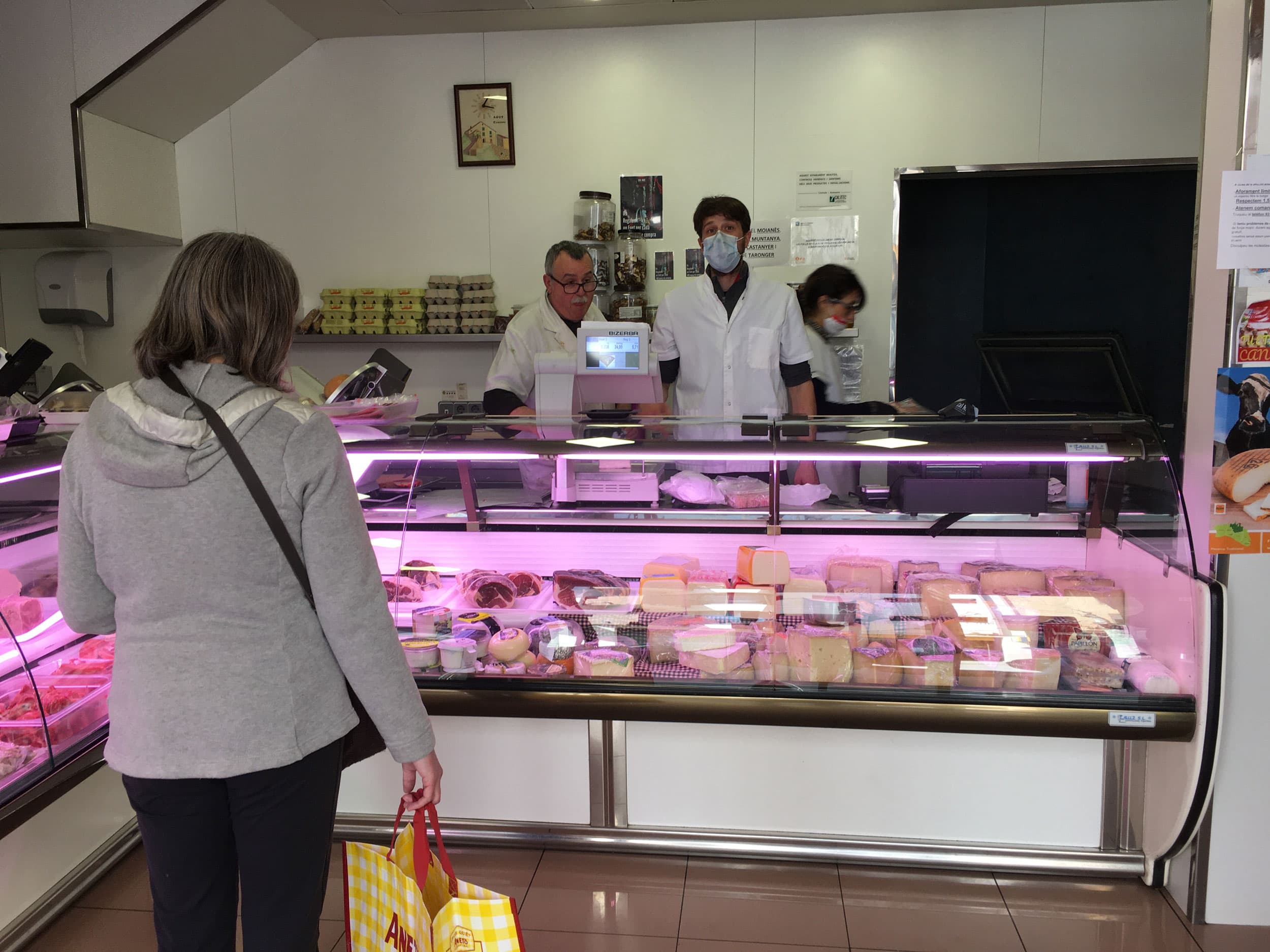 Clerks in masks at a cheese shop