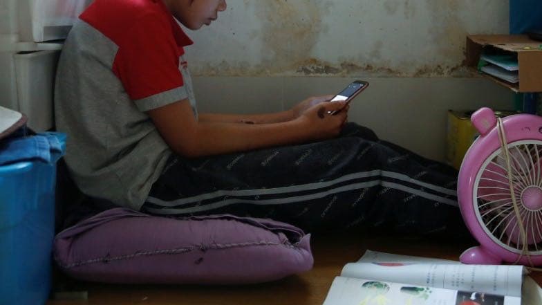 Secondary school student Wendy attends an online class with a smartphone at home during the novel coronavirus disease (COVID-19) outbreak, in Hong Kong, China, March 16, 2020.