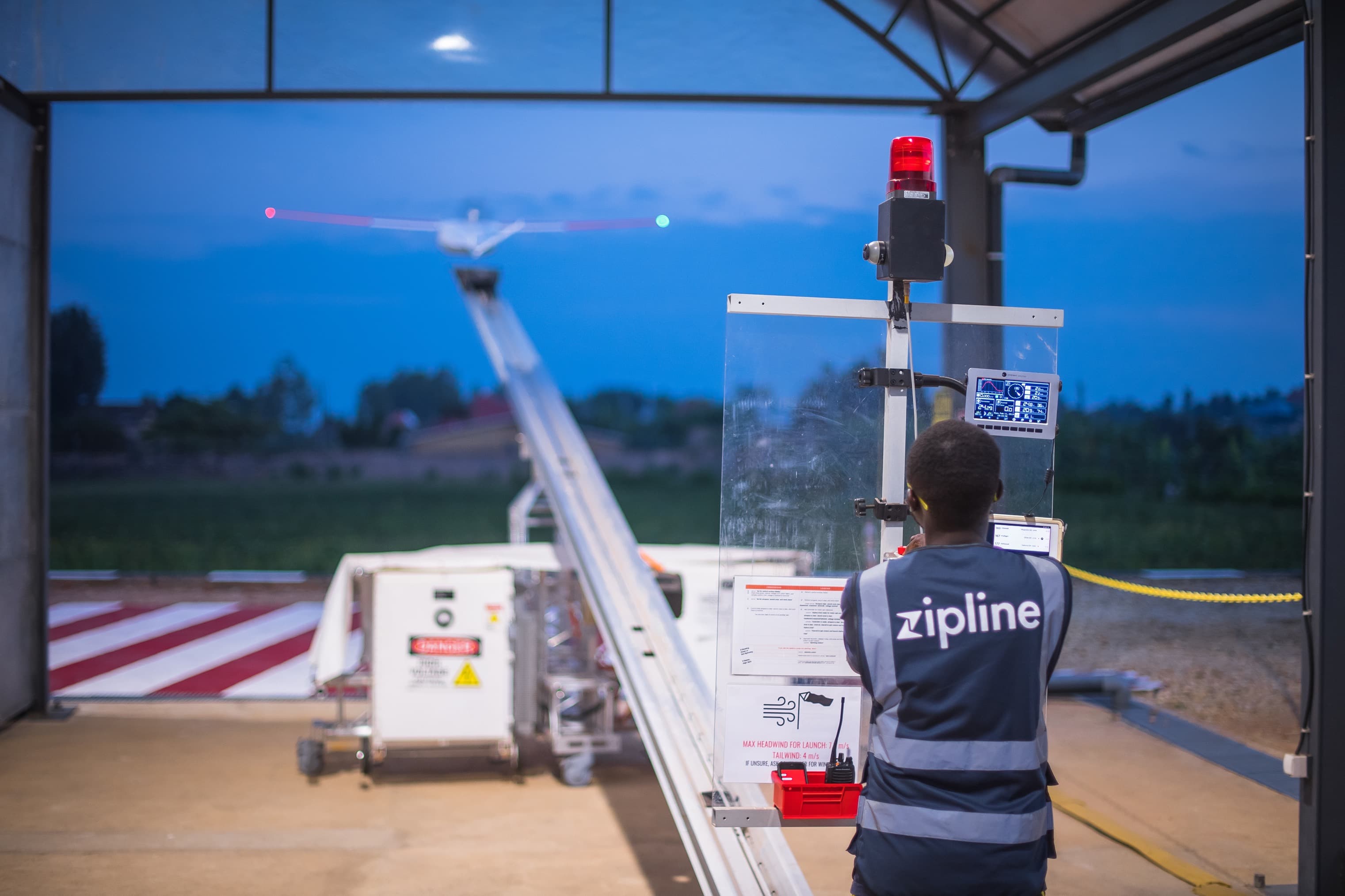 a man looks at a drone flying.