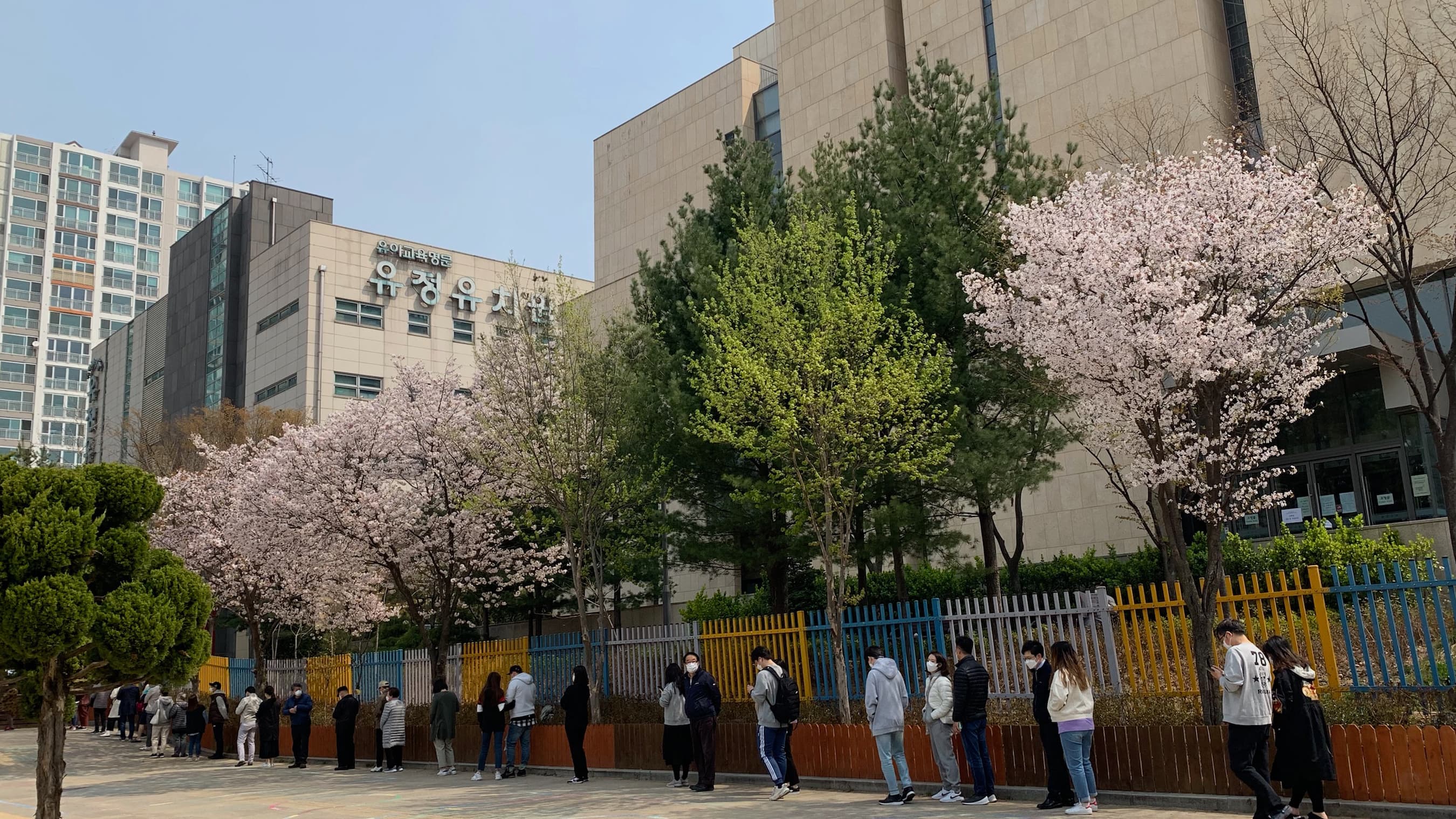 Voters line up to cast ballots outside in South Korea