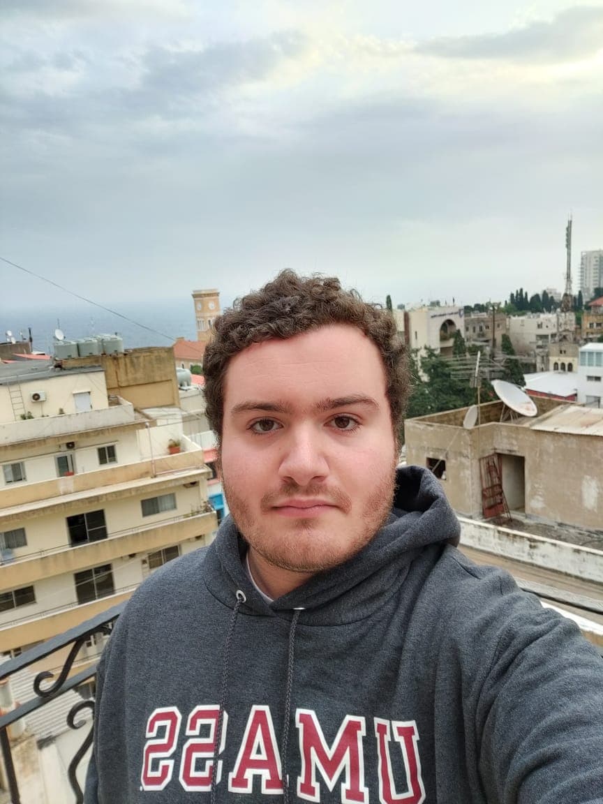 A young man wears a university shirt