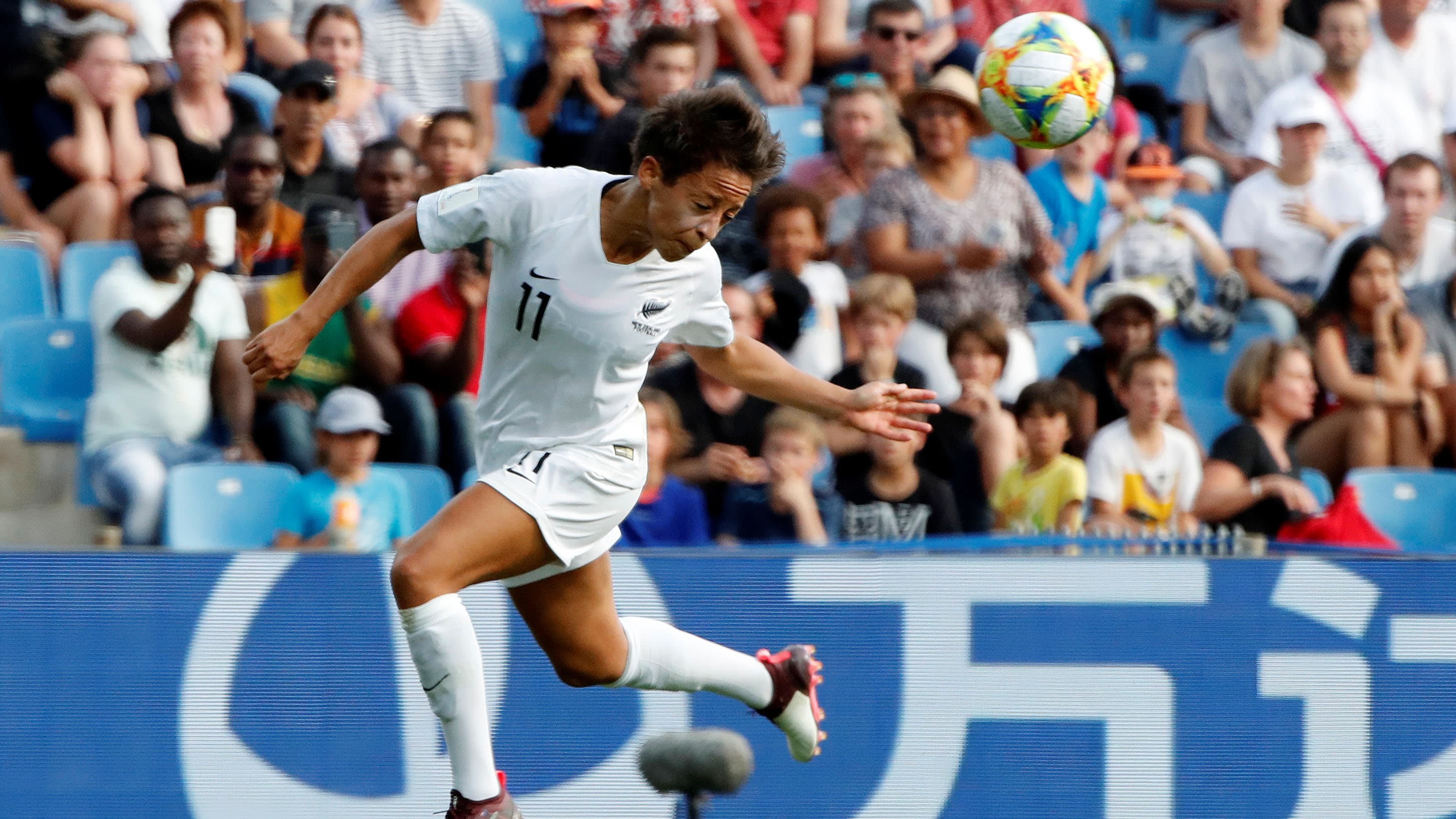 An action shot of a woman playing soccer