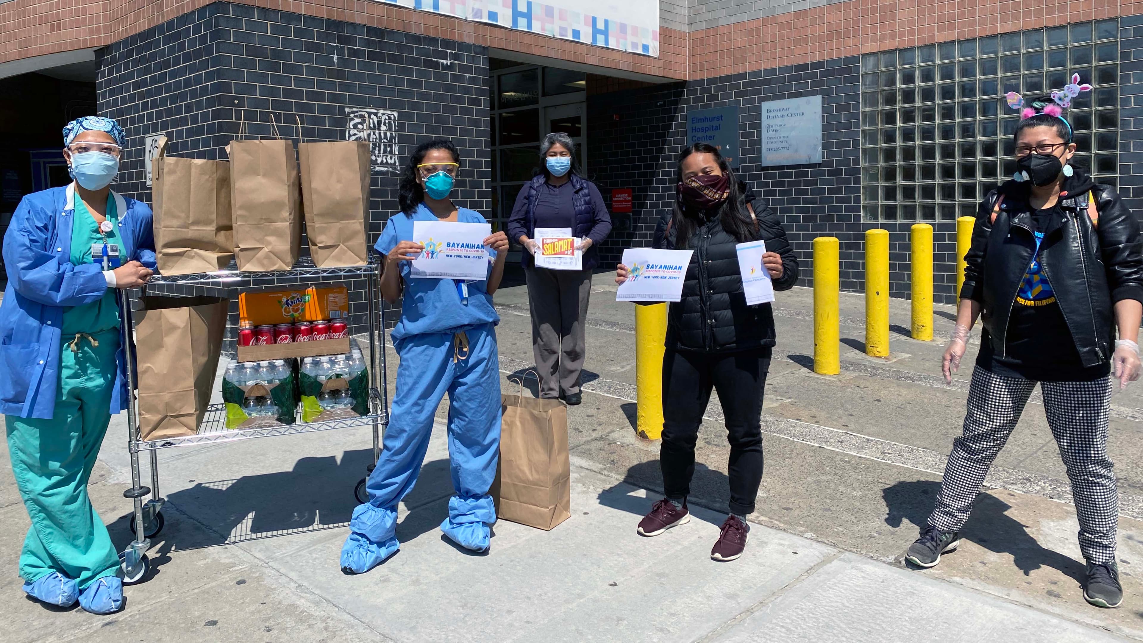 Filipino nurses on the front lines of the coronavirus pandemic at Elmhurst Hospital in Queens, New York City, pose with donated food from Meals to Heal, a Filipino American community initiative.