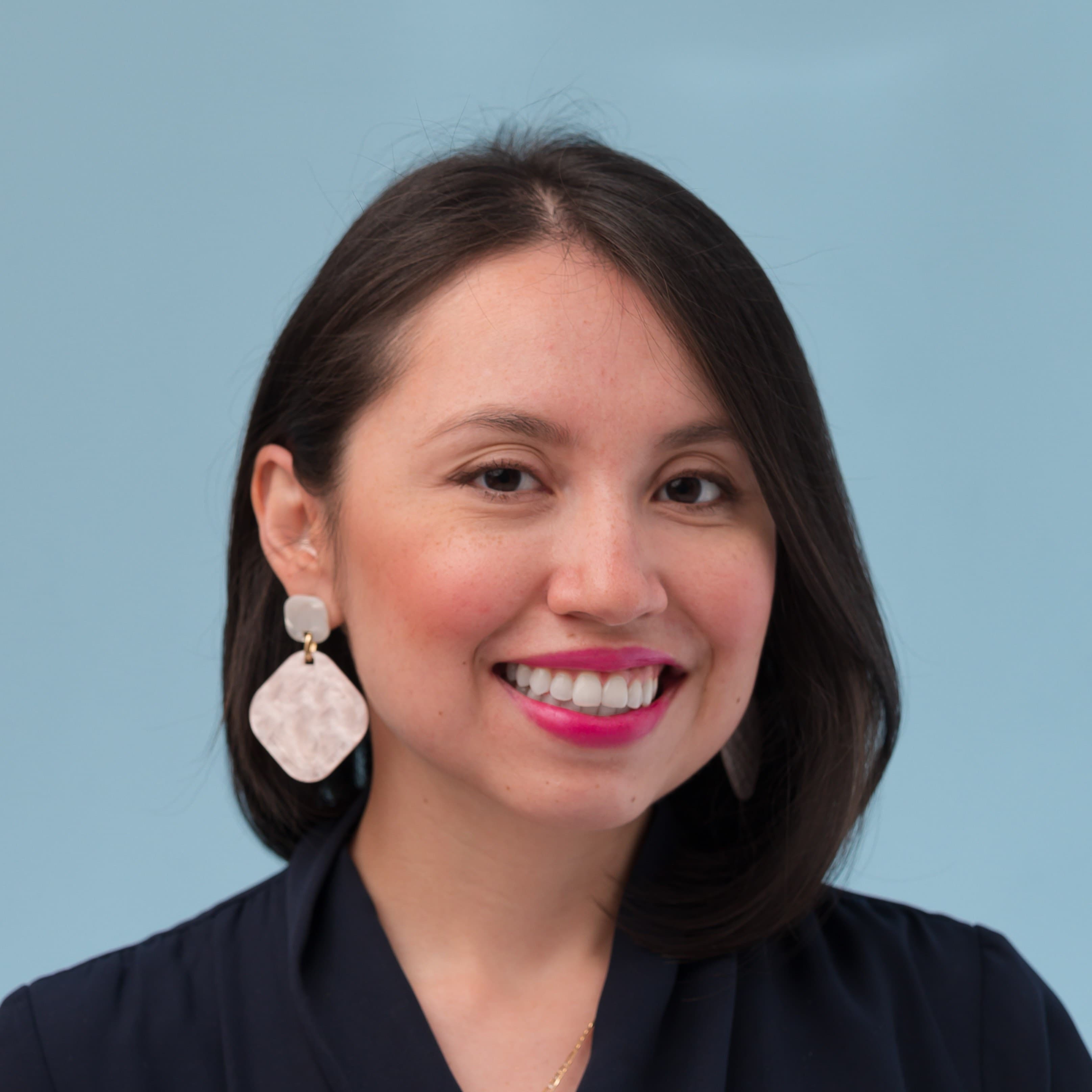 A woman looks at the camera.