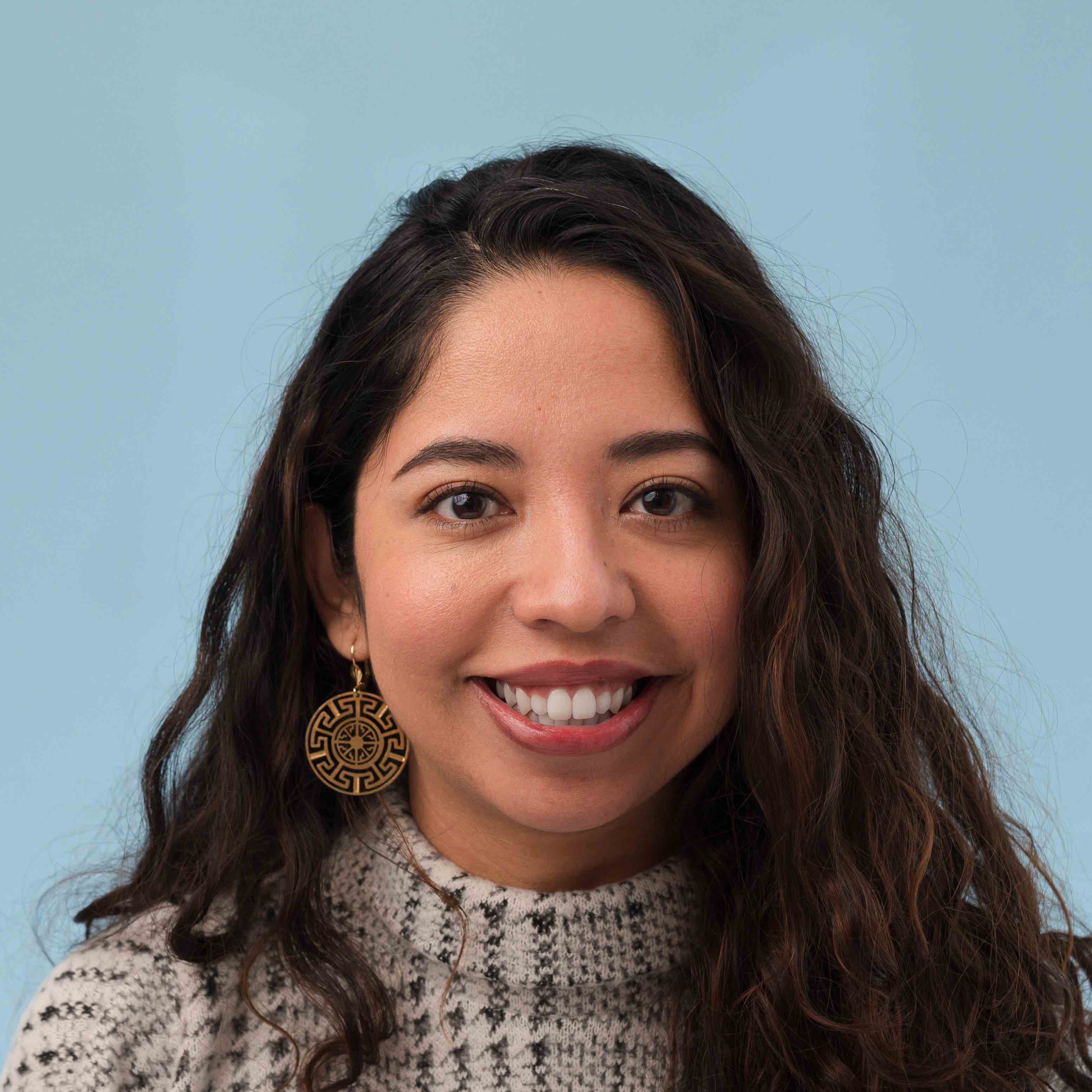 A woman smiles while posing for a photo.