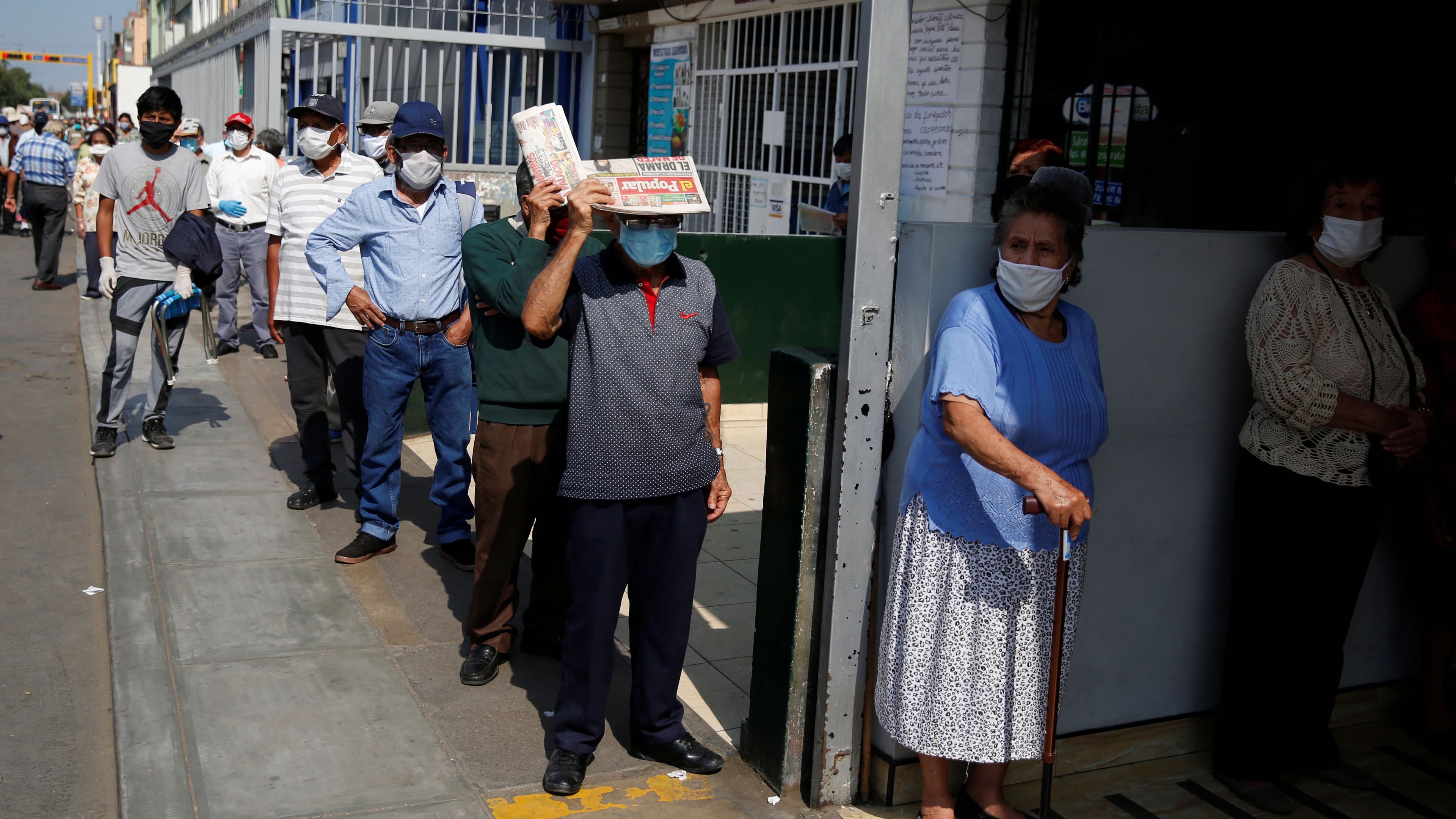 People wait outside Lima's central market as Peru extended a nationwide lockdown amid the outbreak of the coronavirus disease (COVID-19), May 8, 2020.