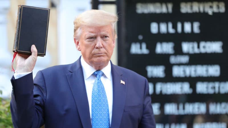 President Trump holds up a Bible.