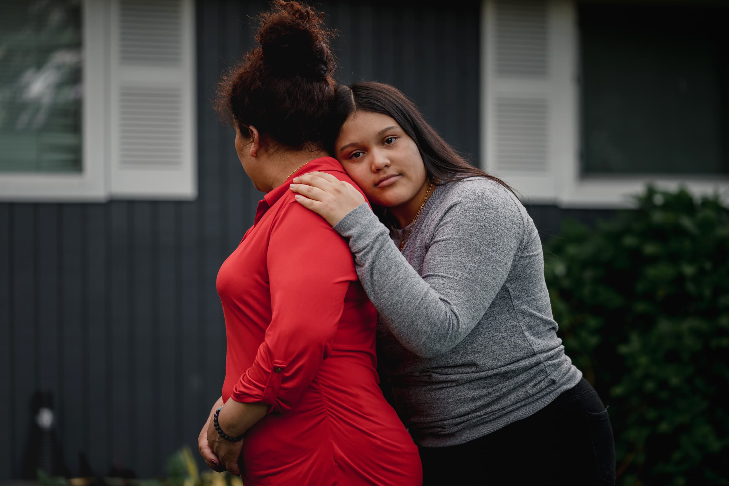 A young woman poses for a photo with her mother.