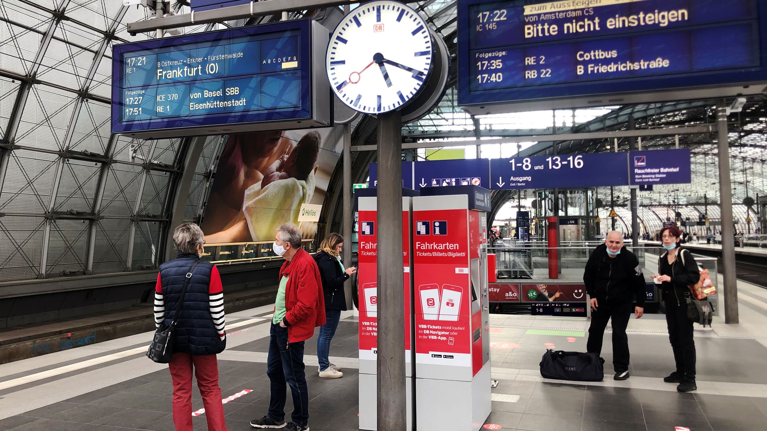 People stand on a train platform