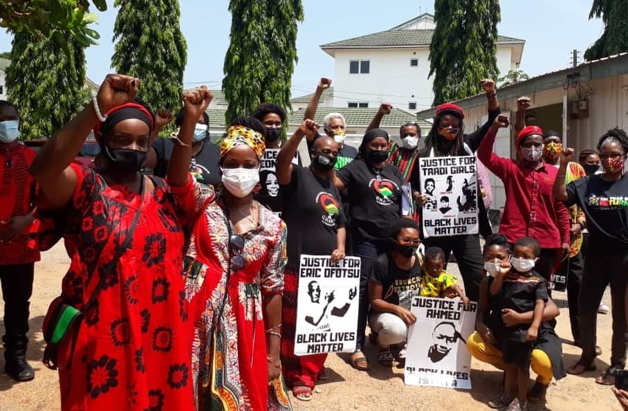 People with signs and raising fists