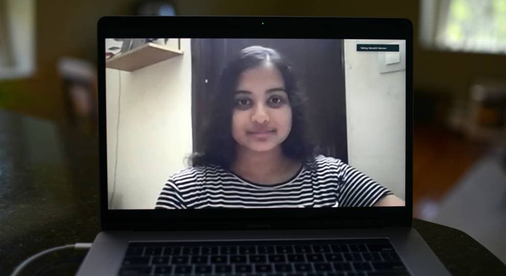 A young woman on a laptop screen