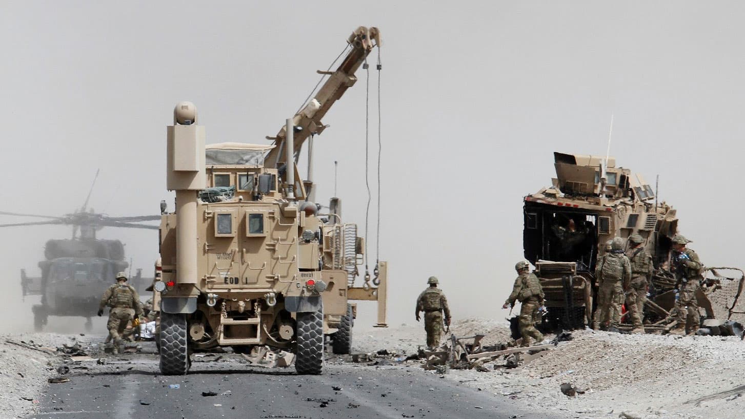 A photo of troops and military vehicles