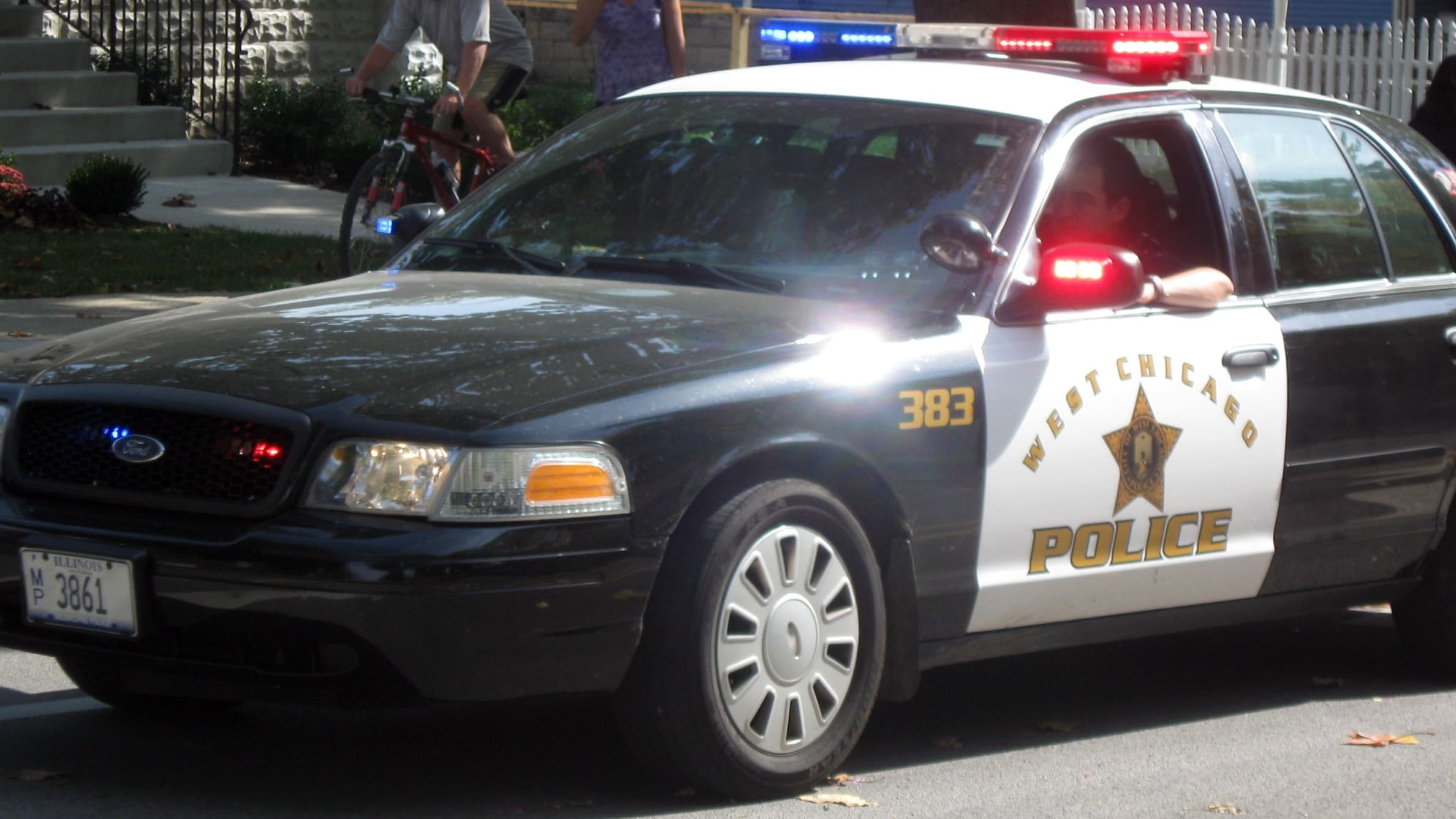 A police car with red and blue lights flashing