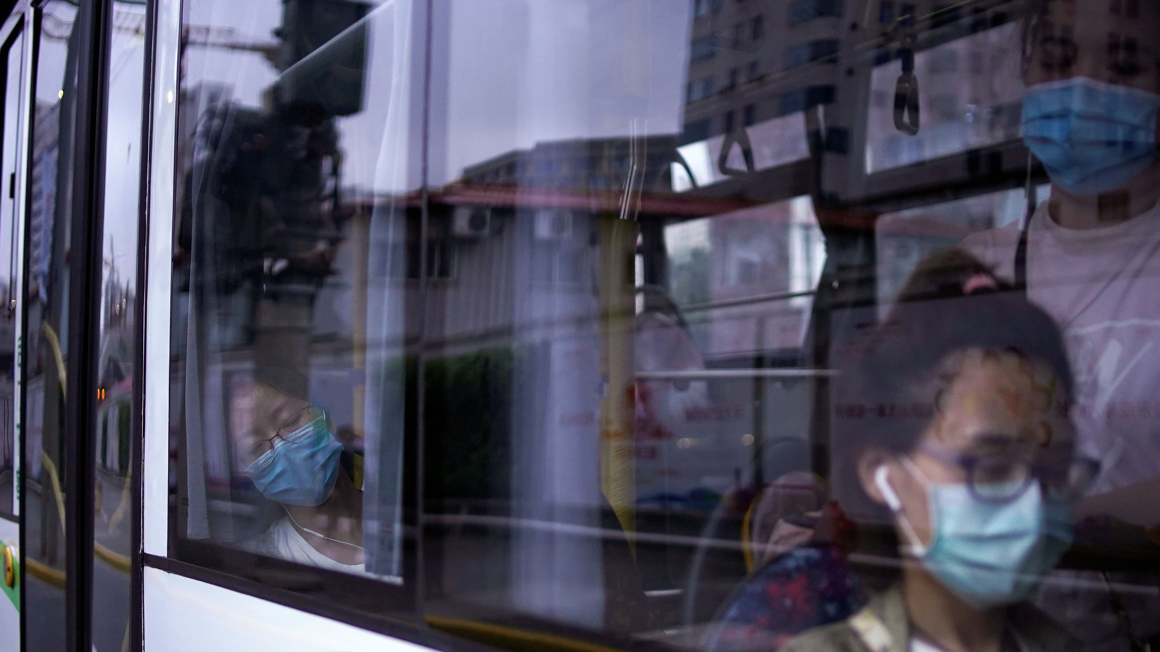 Women wearing protective face masks are seen in a bus, following the coronavirus disease (COVID-19) outbreak, in Shanghai, June 9, 2020. 