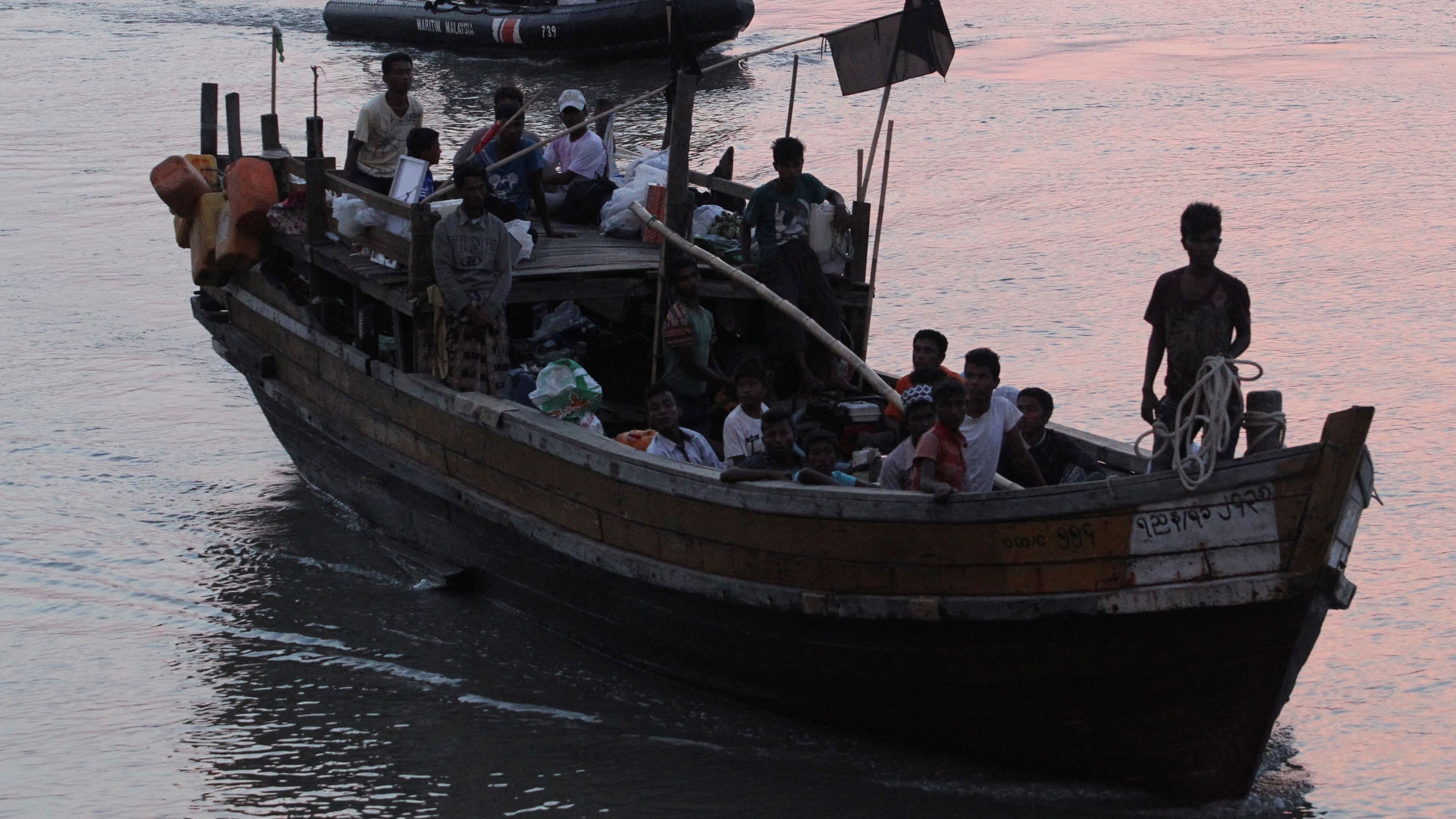 Rohingya refugees who were intercepted by Malaysian Maritime Enforcement Agency off Langkawi island, are escorted in their boat as they are handed over to immigration authorities, at the Kuala Kedah ferry jetty in Malaysia, April 3, 2018.