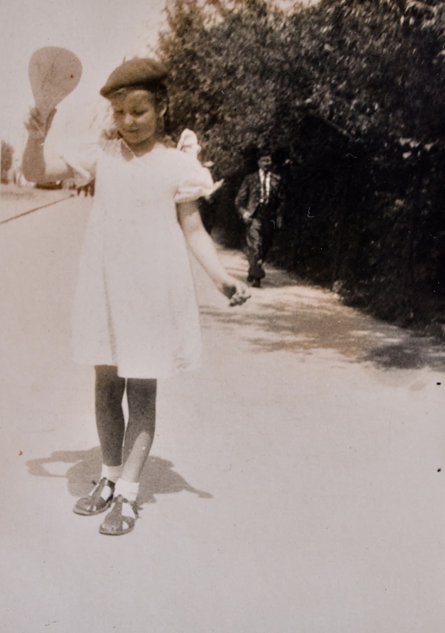 An old, black and white photograph of a young girl
