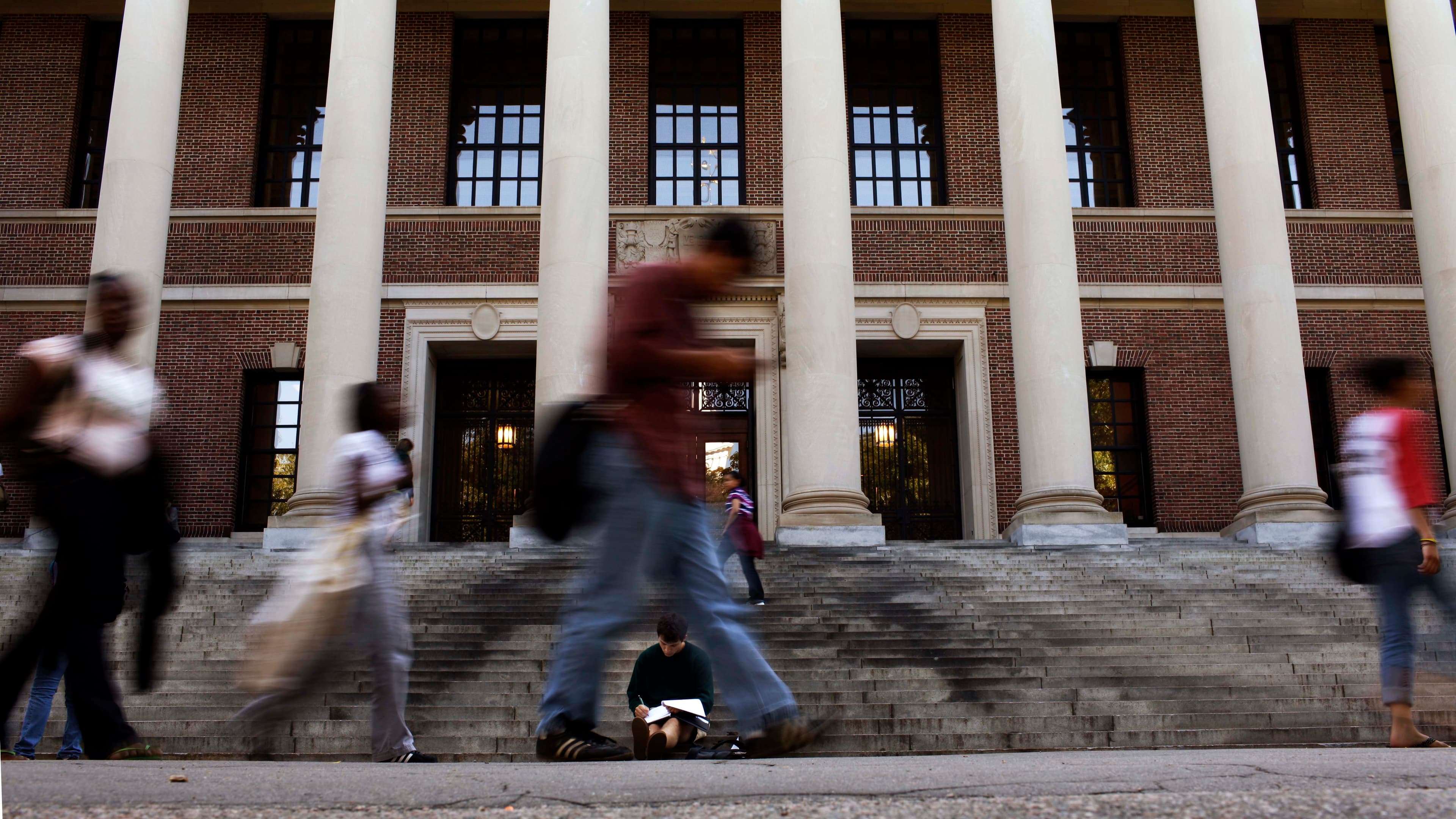 A students sits on the steps of Widener Library at Harvard University in Cambridge, Massachusetts, on Sept. 21, 2009.