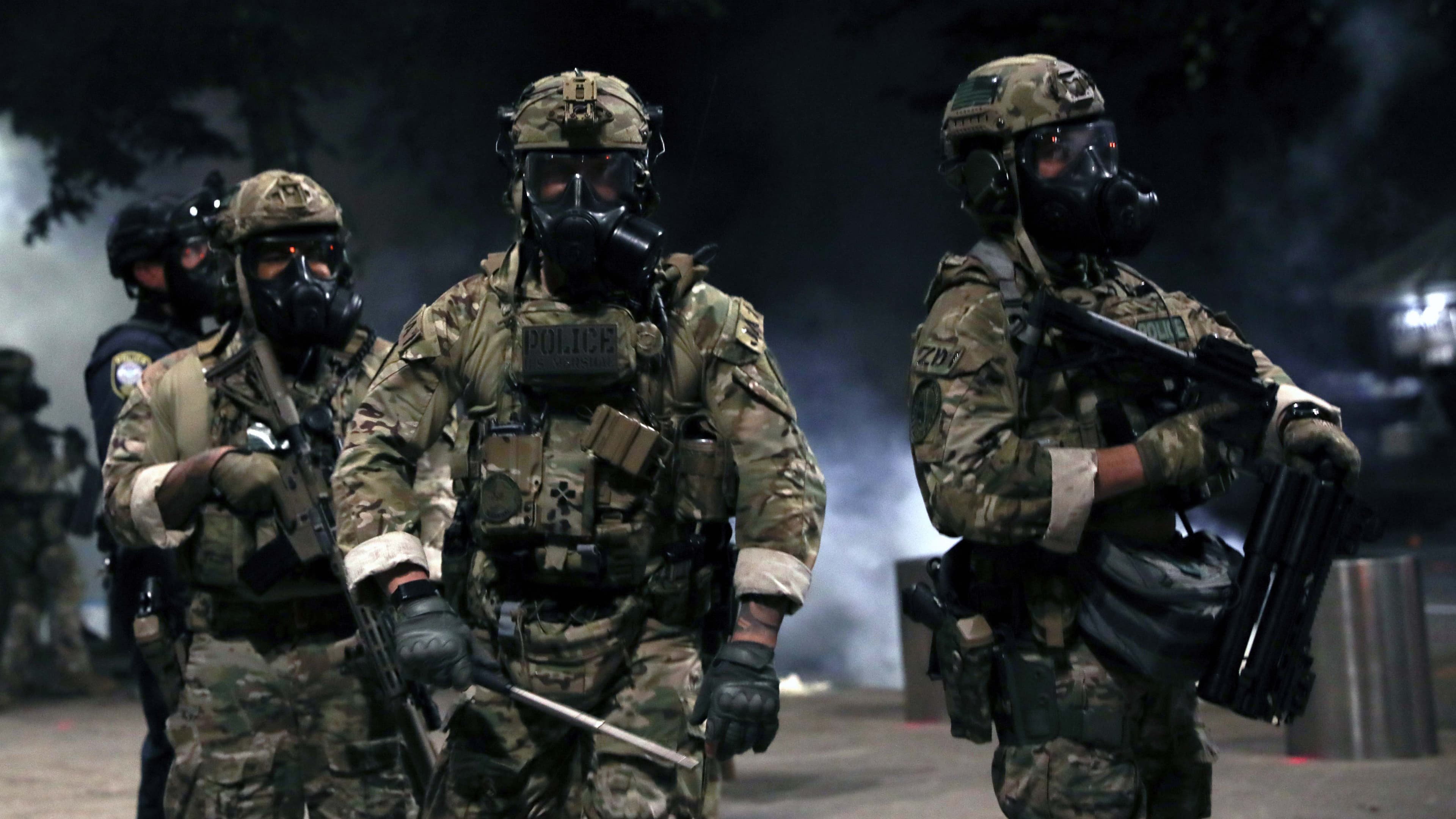 Federal law enforcement officers are seen during a demonstration against the presence of federal law enforcement officers and racial inequality in Portland, Oregon, July 21, 2020.