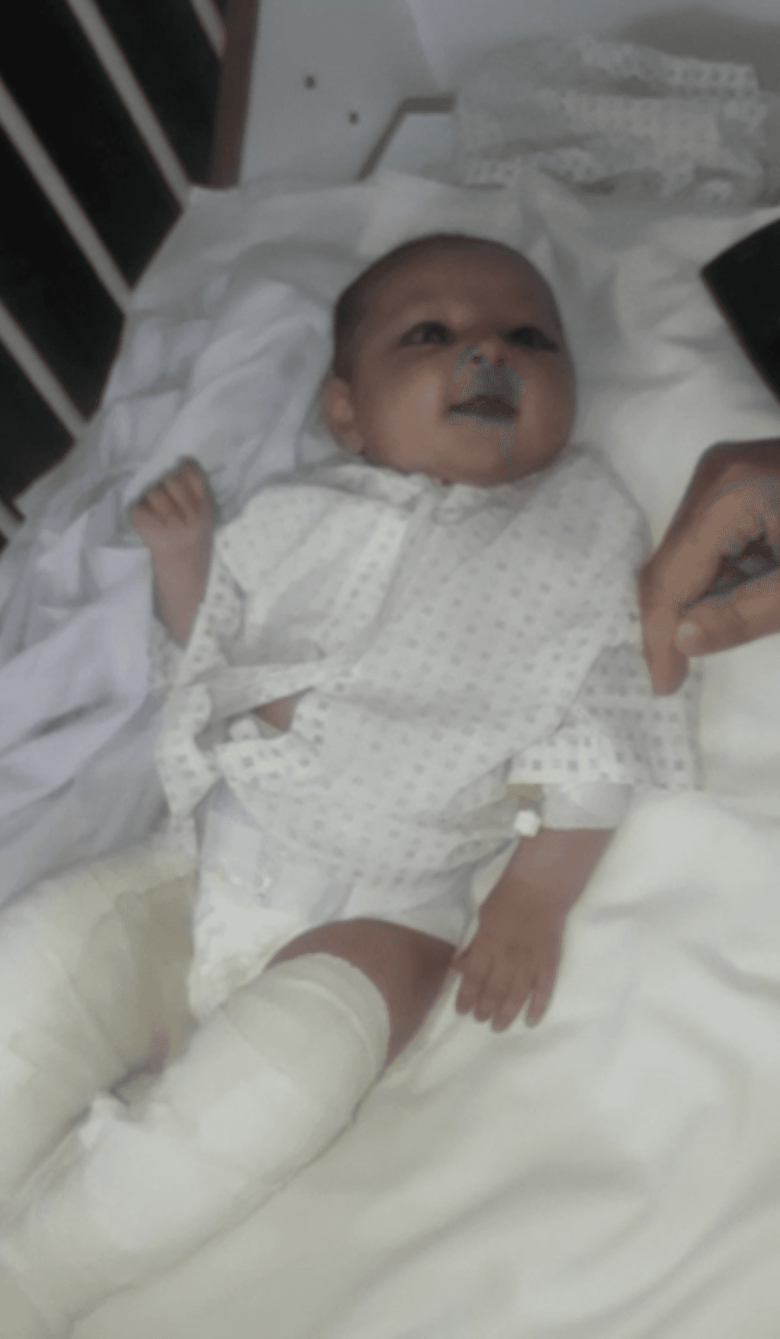 Ameneh Sharifi, her legs in bandages, smiles in a family video as she recovers.