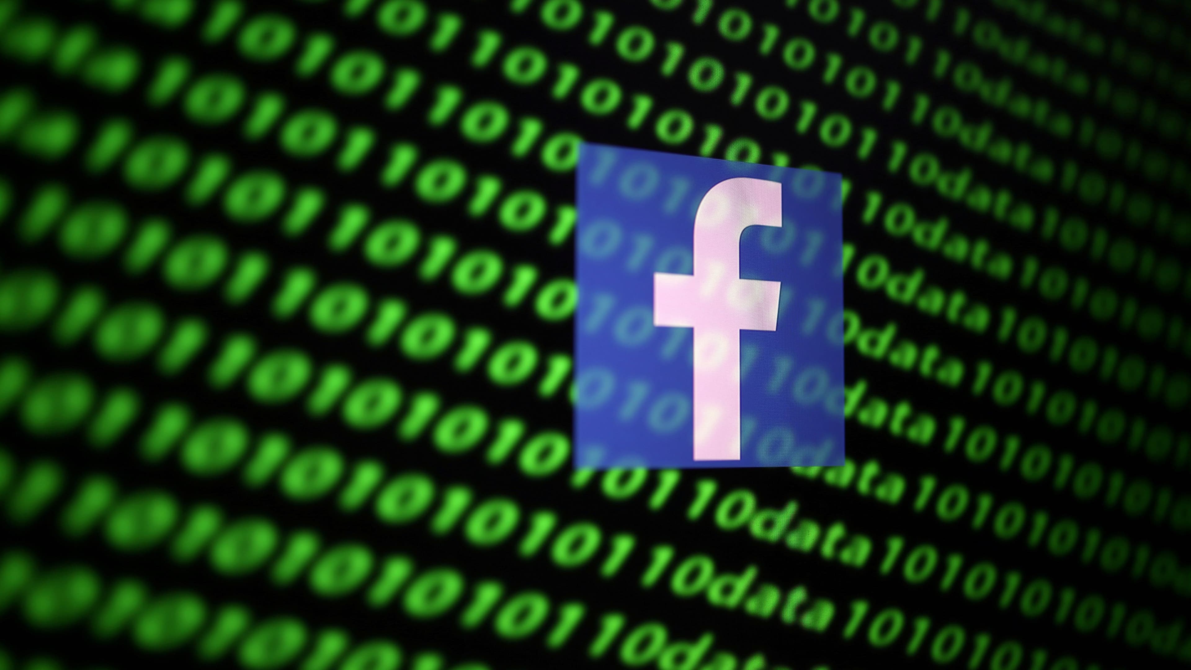 The Facebook logo and binary cybercodes are seen in this illustration dating to Nov. 26, 2019.