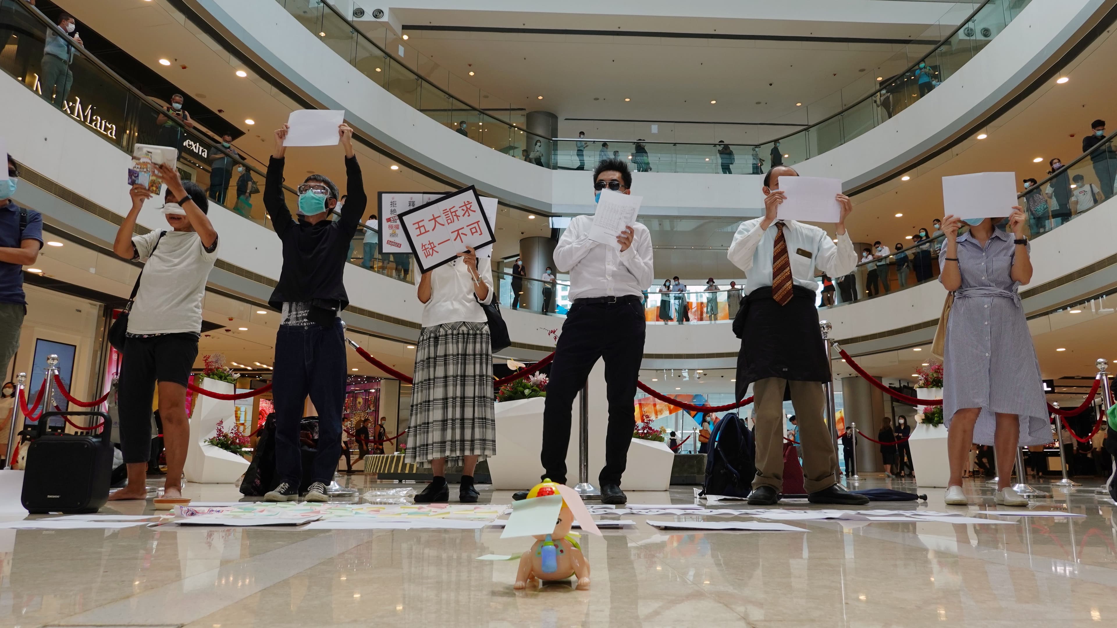 Pro-democracy demonstrators take part in a lunchtime protest against the national security law, at a shopping mall in Hong Kong, July 6, 2020.