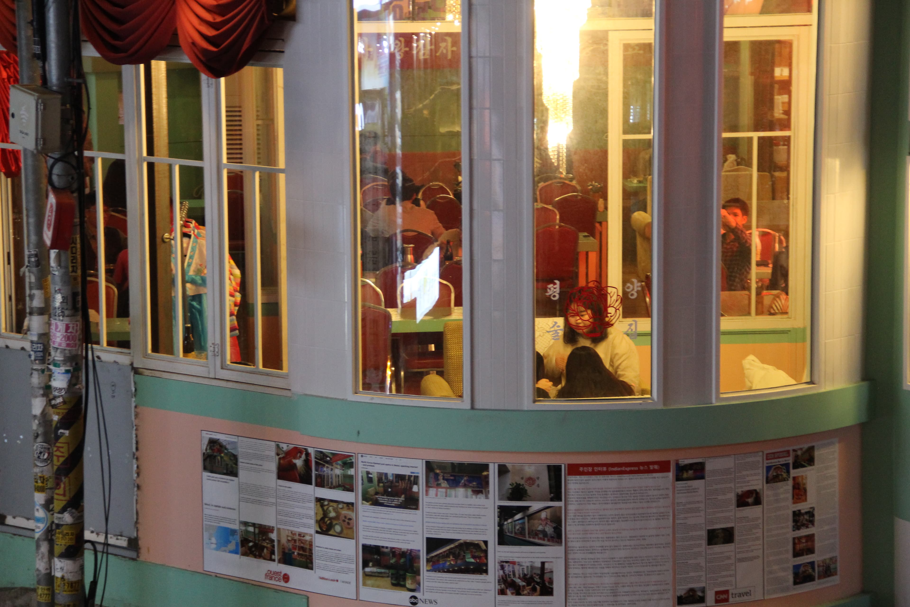 Articles about the pub published by foreign media outlets are taped on the mint walls outside which are reminiscent of North Korea’s pastel-colored buildings.