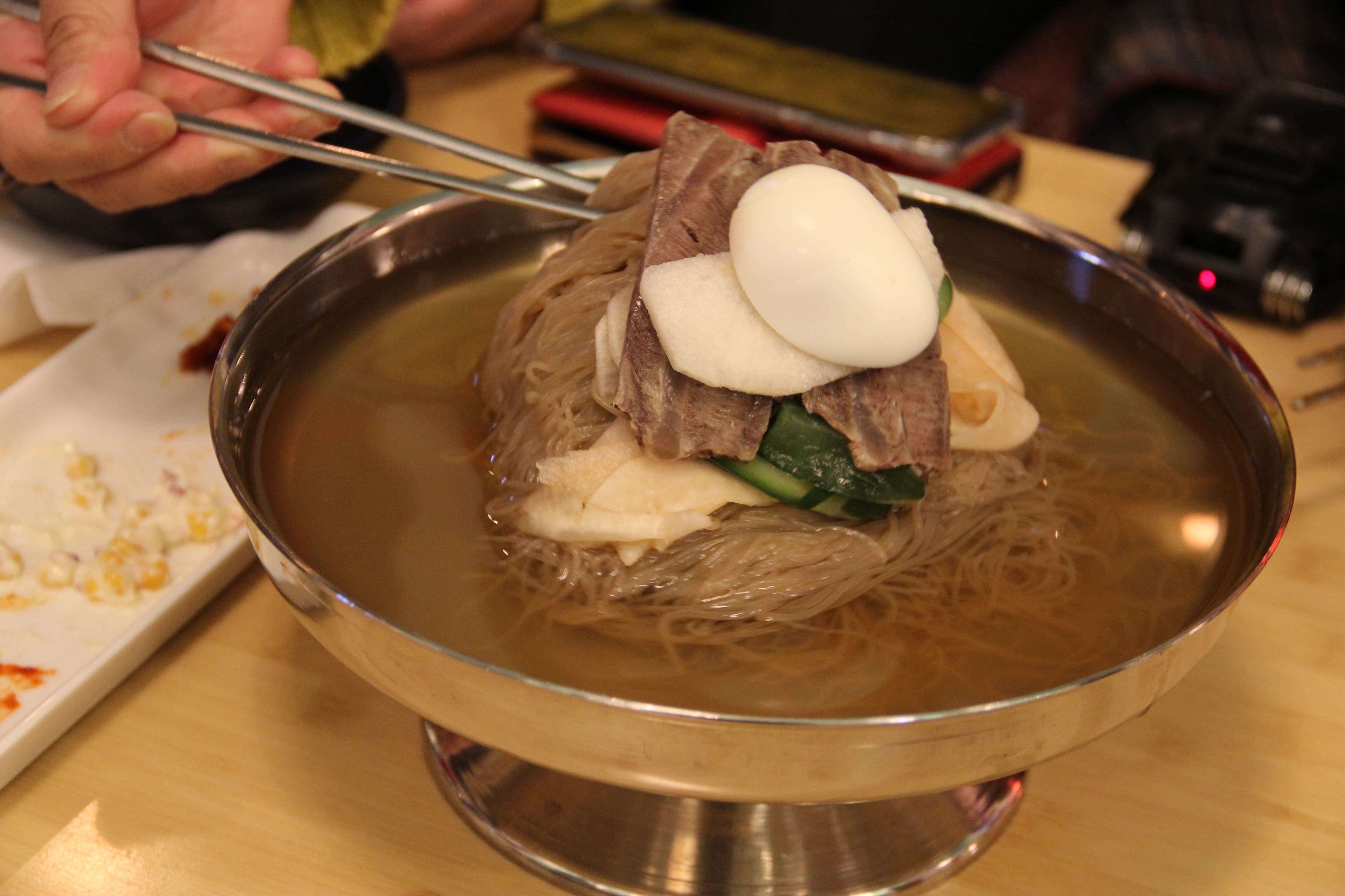 Kim Eun-joo was surprised that the mool naengmyun (cold noodles) were served in a wide-rimmed brass goblet, just like in North Korea.