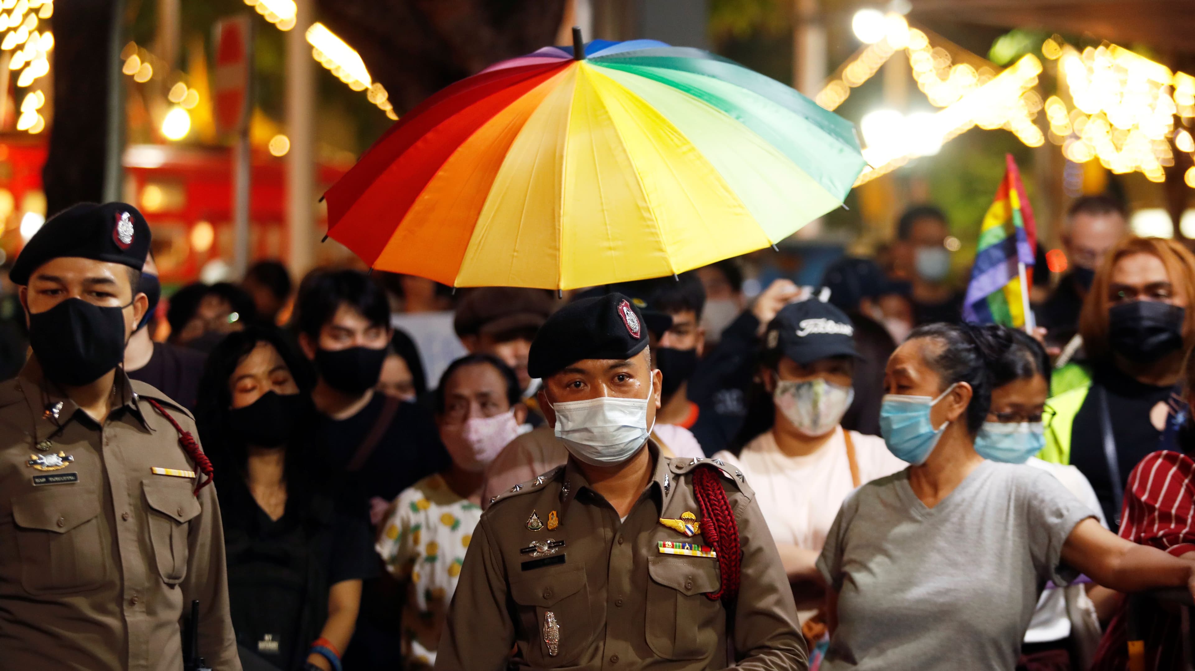 Thai police officers stand among demonstrators during a protest demanding the resignation of Thailand's Prime Minister Prayuth Chan-o-cha, in Bangkok, Thailand, July 25, 2020.