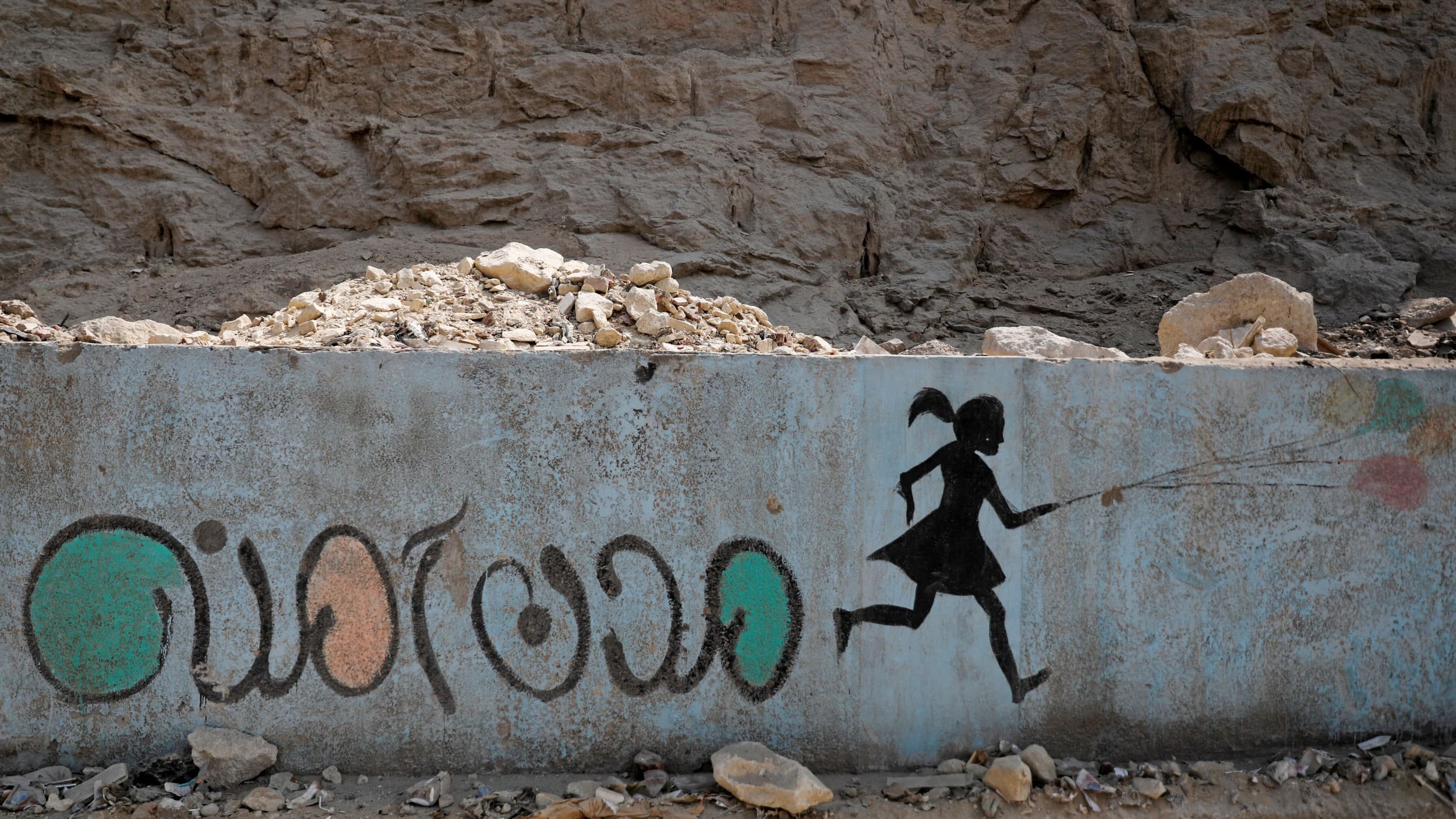 In this file photo, a mural depicting messages against sexual harassment and reading "safe cities" in Arabic script is seen on a highway in Cairo, Egypt, Sept. 3, 2018.