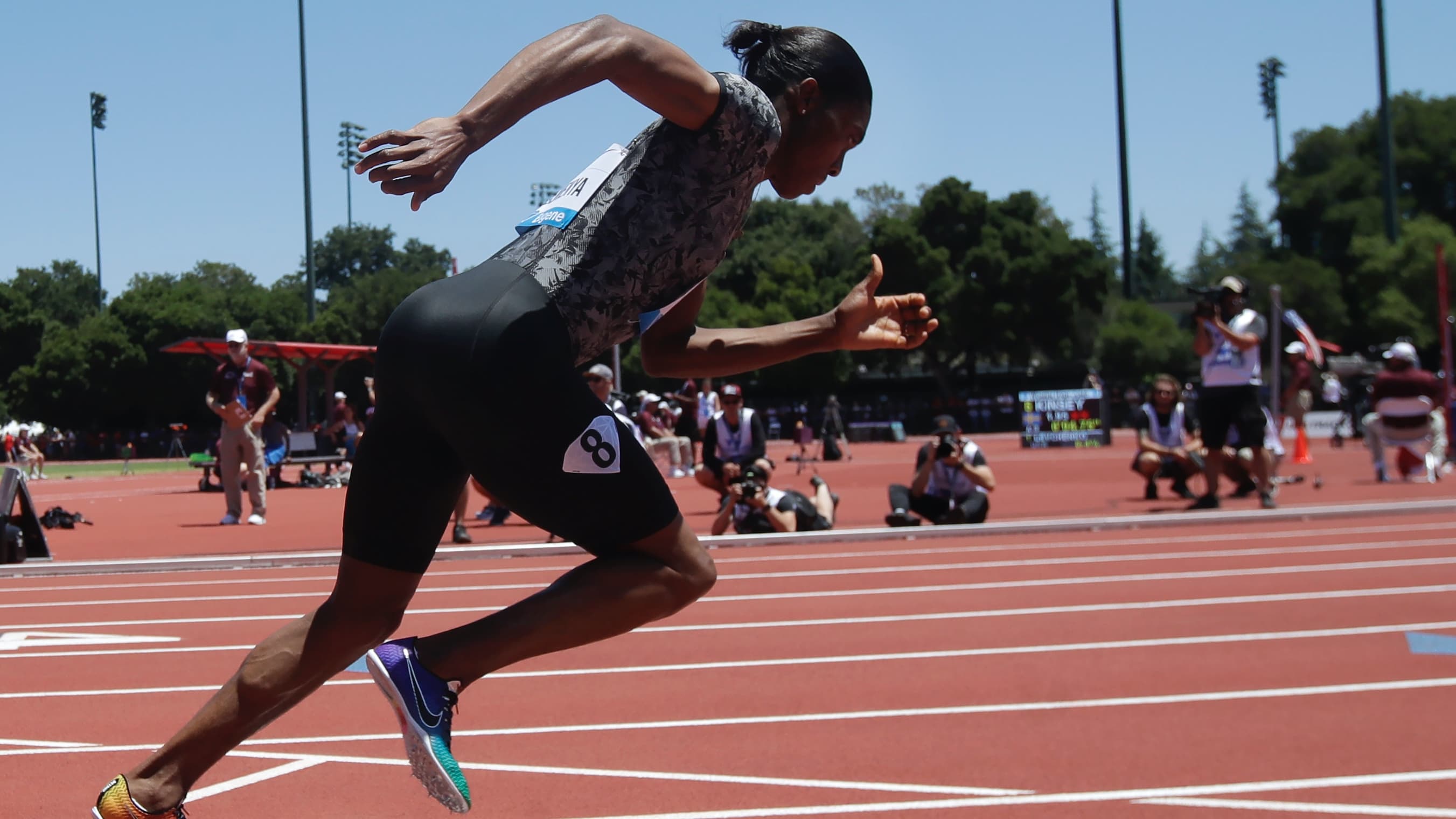 Caster Semenya wears a track and field outfit and sets off on a race