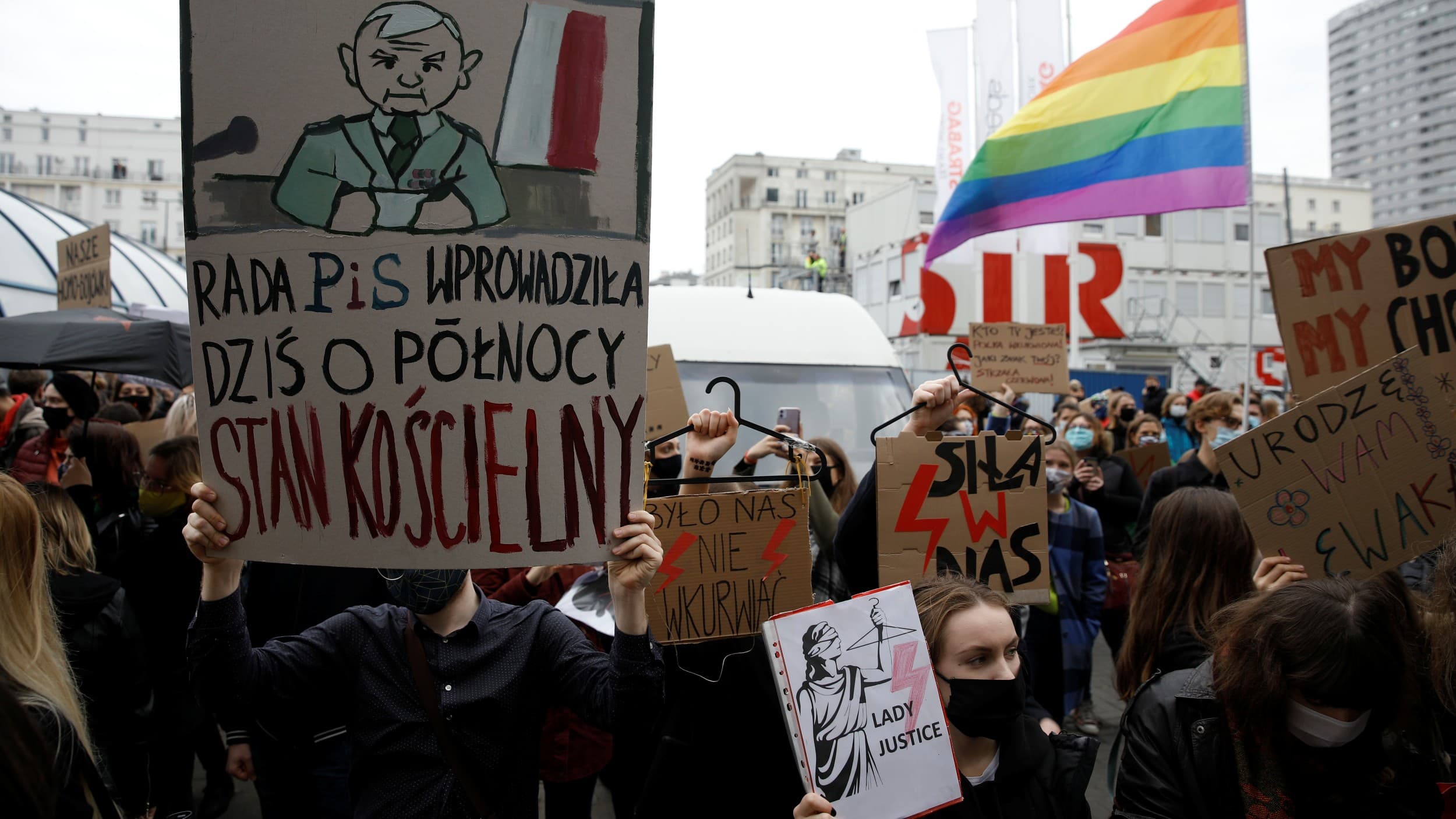 People take part in a protest against the ruling by Poland's Constitutional Tribunal that imposed a near-total ban on abortion in Warsaw, Poland, Oct. 28, 2020. The banner reads: "The Law And Justice Council introduced the church law at midnight today." 