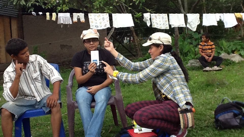 Deaf youth with Deaf outreach workers (photo taken in a rural location outside Condega).