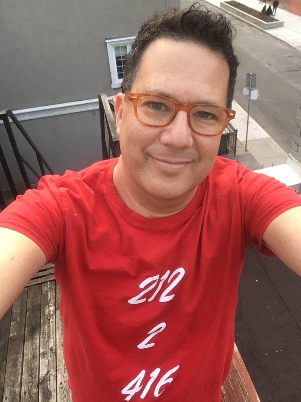 Stephen Shainbart, who left New York for Toronto after Trump took office, wears a shirt with the area codes of his previous and current cities.