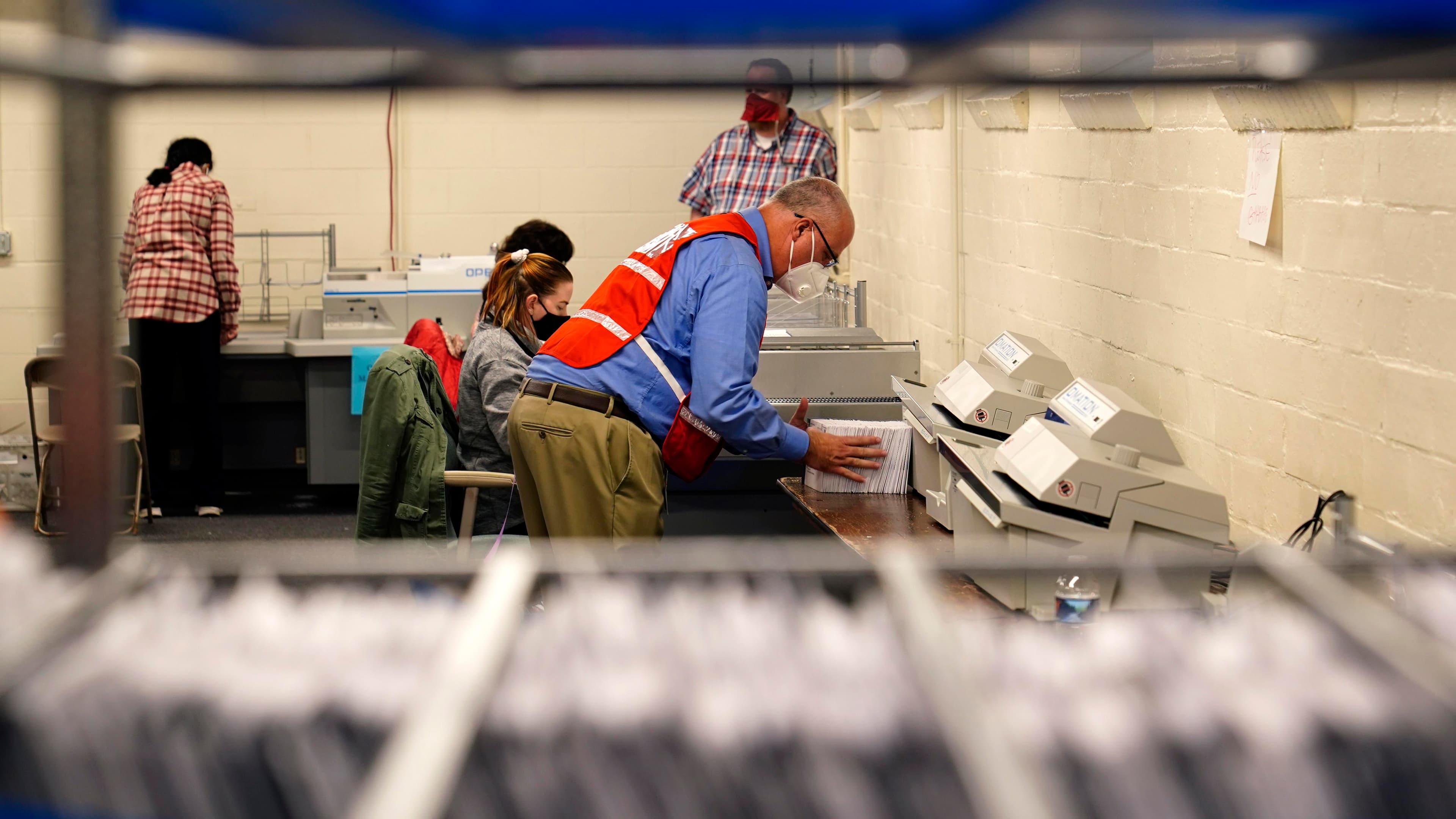 Chester County, Pennsylvania, election workers organize mail-in and absentee ballots for the 2020 General Election in the United States at West Chester University, Nov. 3, 2020.