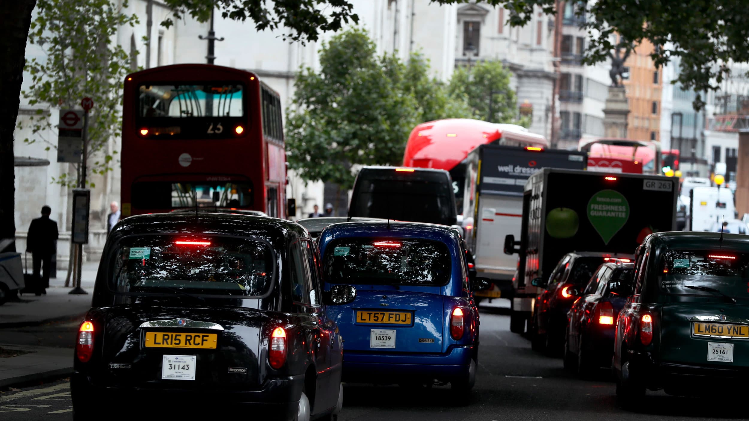 Several vehicles are shown bumper to bumper congested street.
