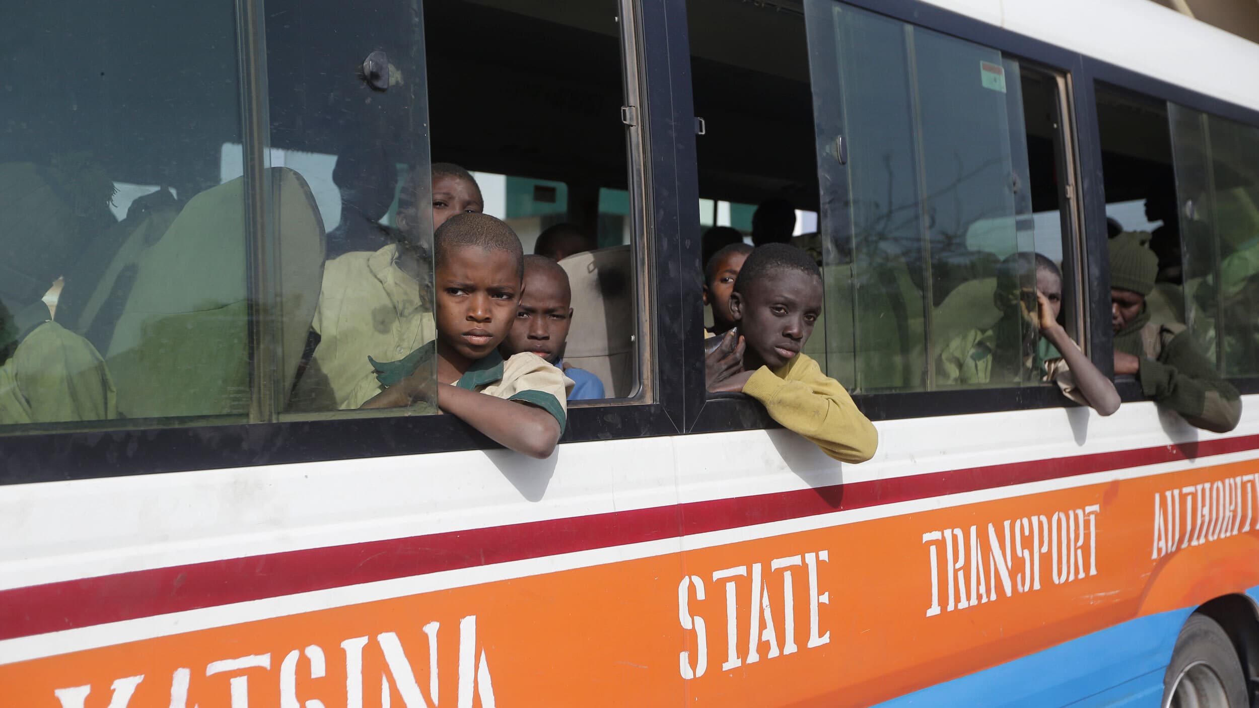 A group of schoolboys are escorted by Nigerian military and officials following their release after they were kidnapped last week, Dec. 18, 2020, Katsina, Nigeria.