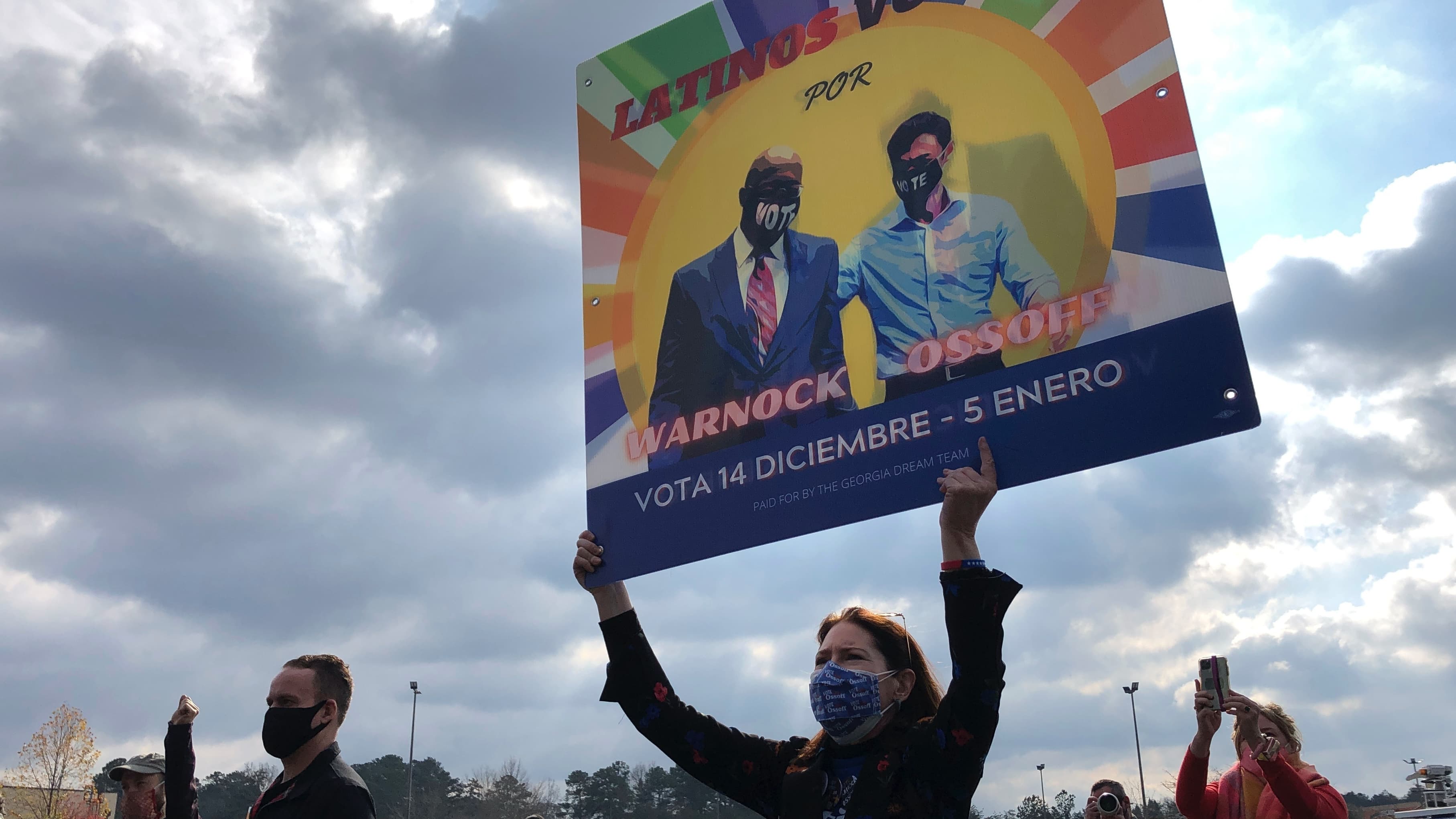 A supporter holds up a large sign during a rally.
