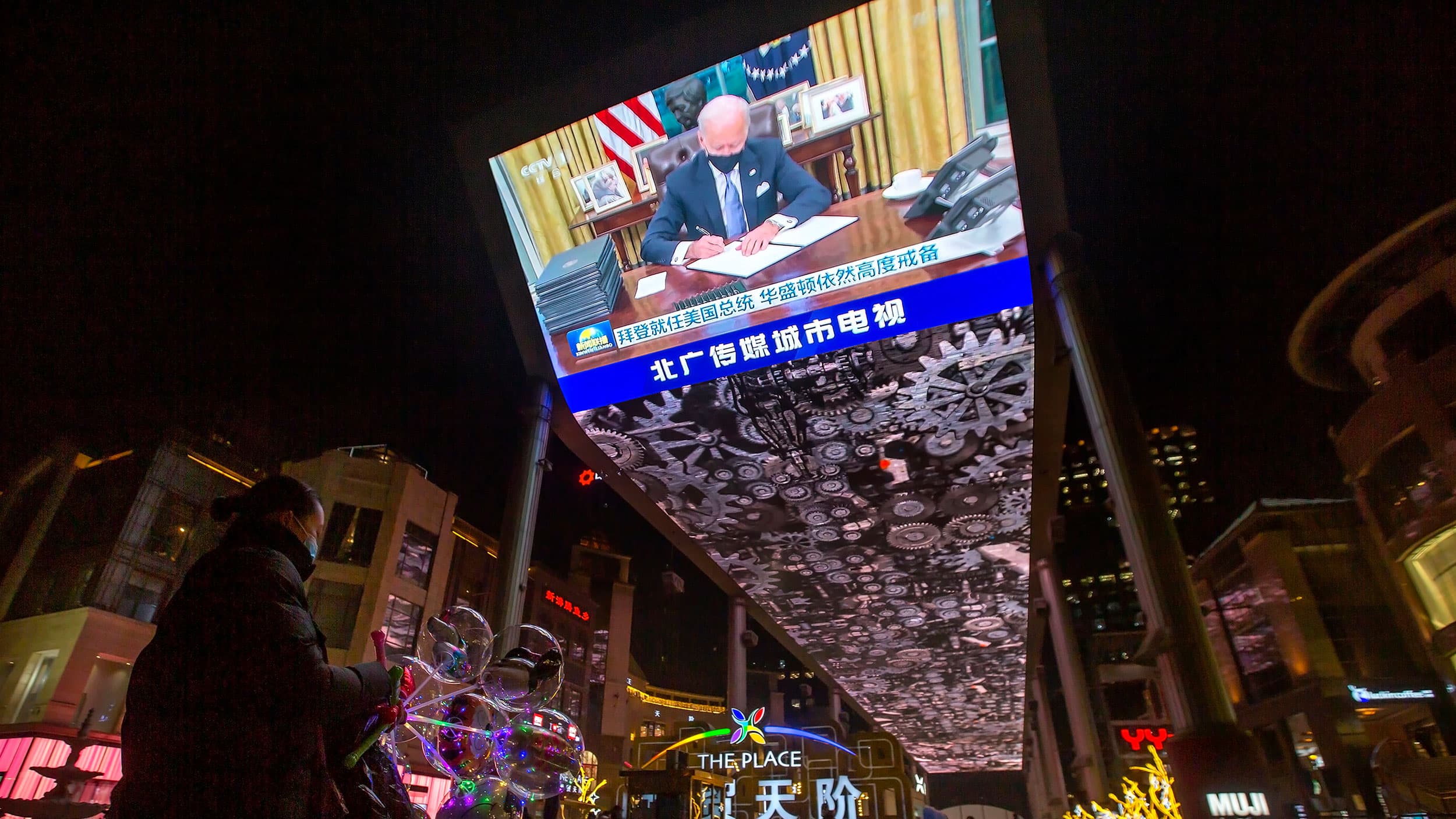 A jumbotron shown from below has newly inaugurated US President Joe Biden on screen.